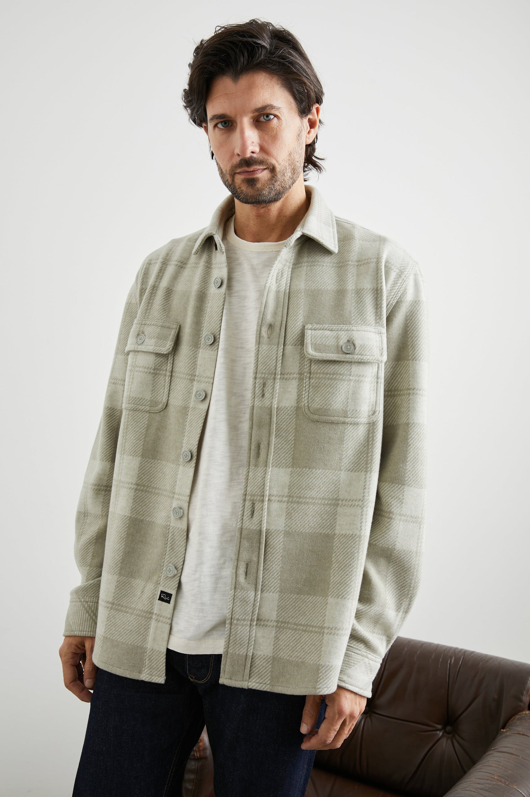 Alder Long-Sleeve Button up with Two Buttoned Chest Flap Pockets in Fawn Cream Colorway, a plaid - Front Unbuttoned View Featured on Model