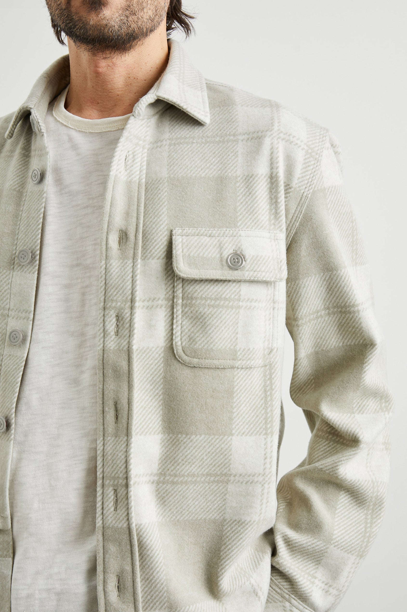 Alder Long-Sleeve Button up with Two Buttoned Chest Flap Pockets in Fawn Cream Colorway, a plaid - Front Unbuttoned View Featured on Model
