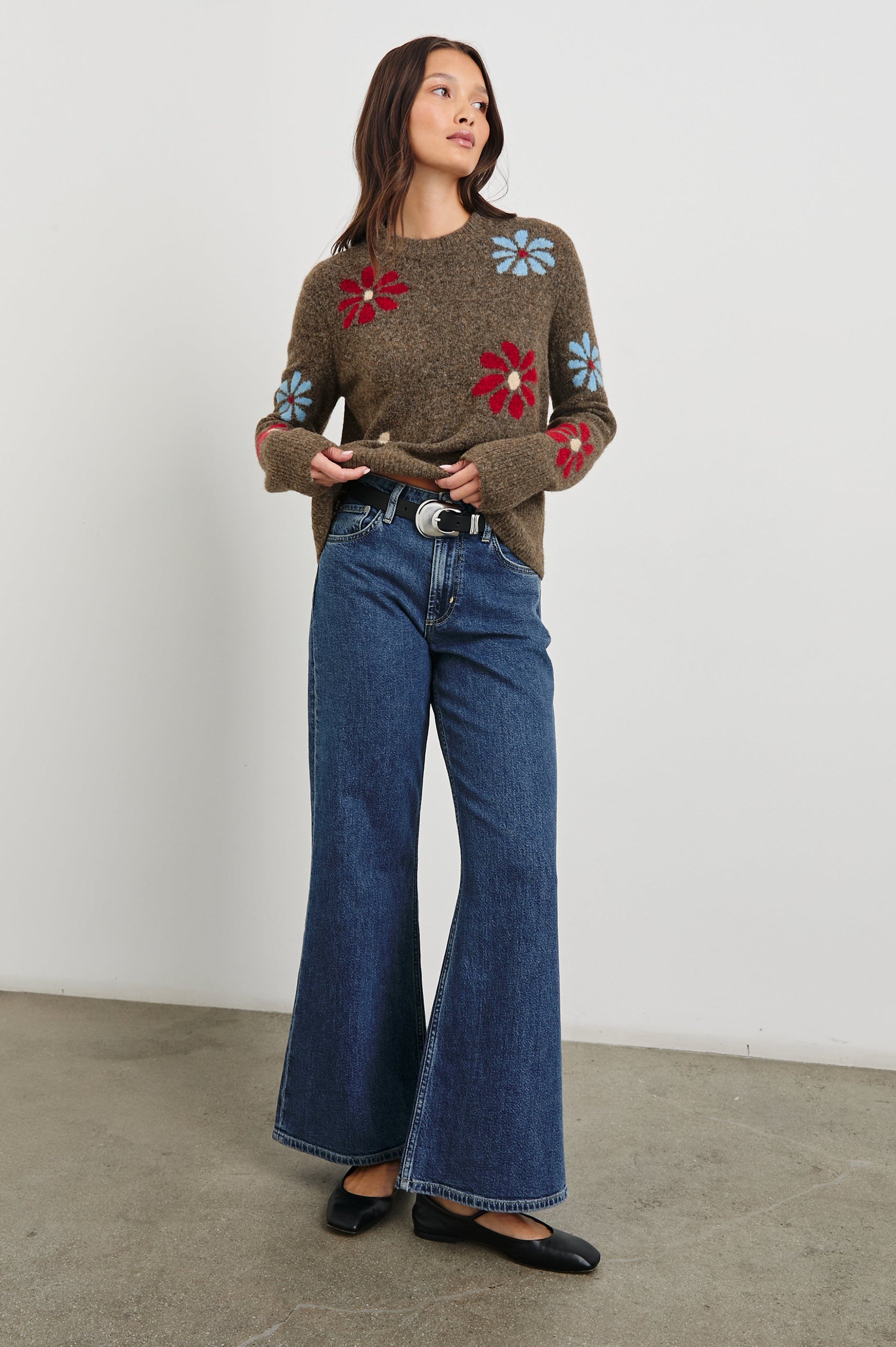 Anise Long-Sleeve Sweater with a Crew Neck and Ribbed Trim in Winter Floral Colorway, with Blue, Cream and Red Flowers on Brown - Front Full Body View Featured on Model