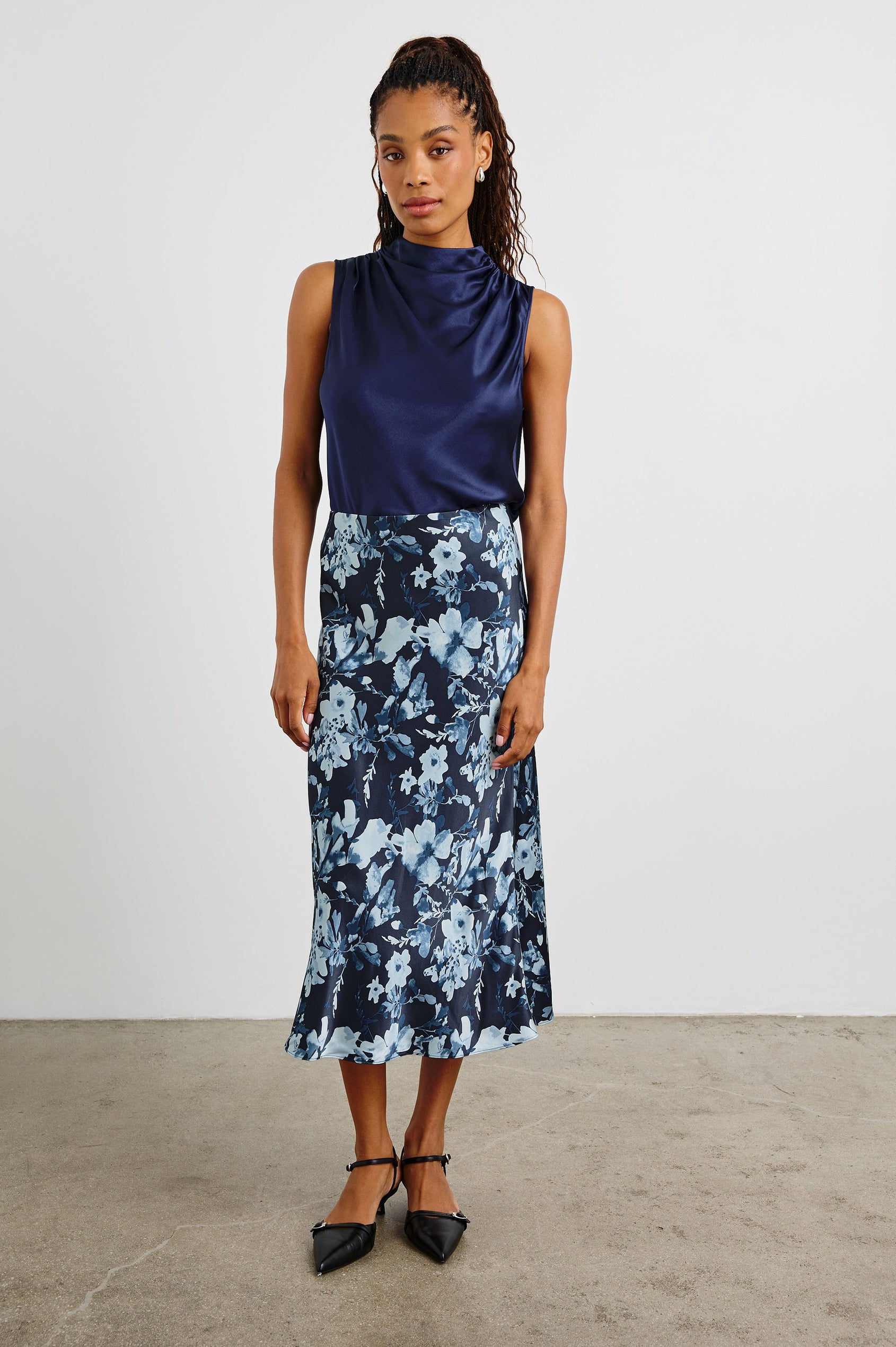 Anya High-waisted Midi Skirt in Indigo Blossoms Colorway, with flowers in Blues on indigo - Front Full Body View Featured on Model