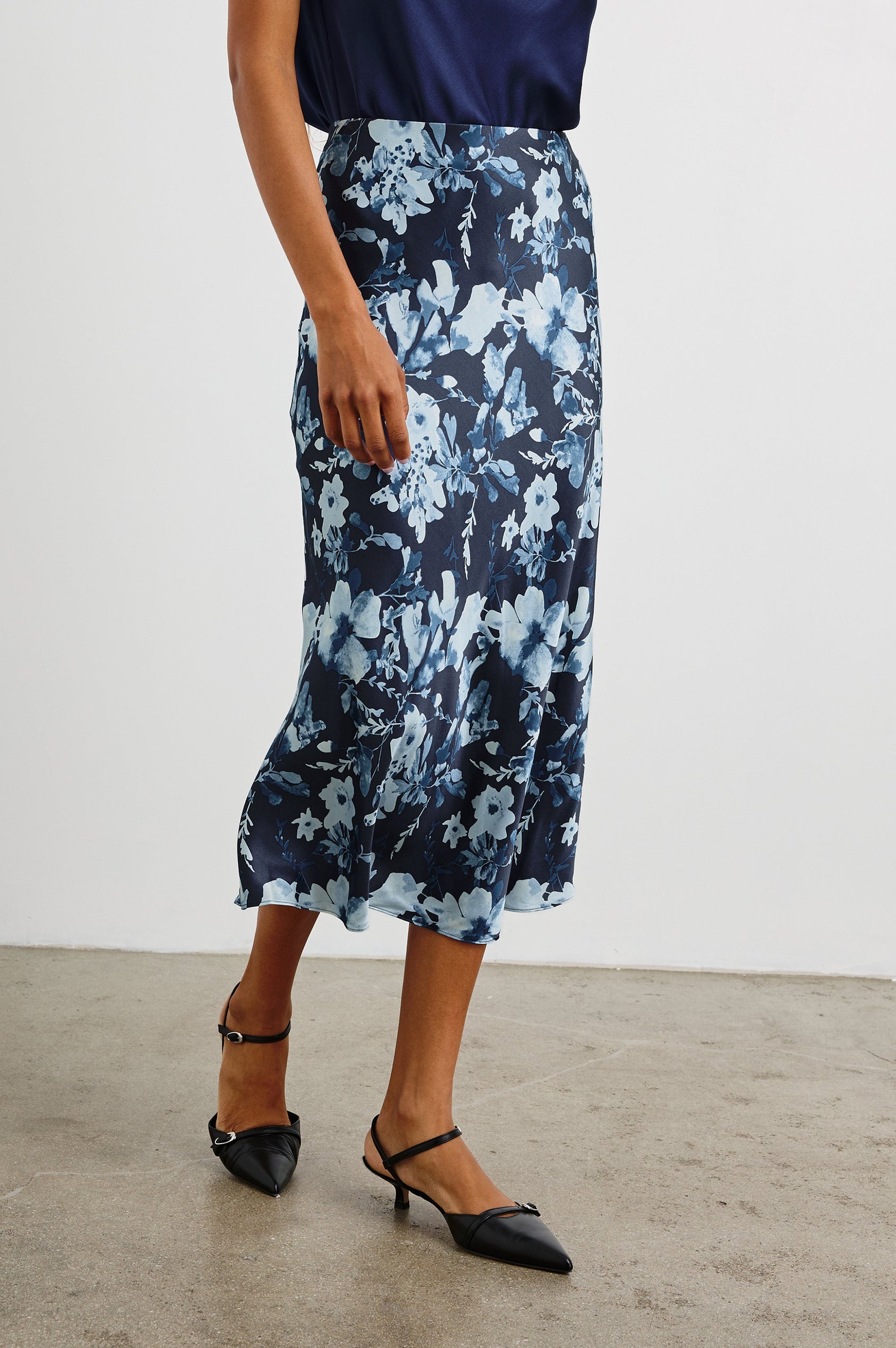 Anya High-waisted Midi Skirt in Indigo Blossoms Colorway, with flowers in Blues on indigo - Front View Featured on Model