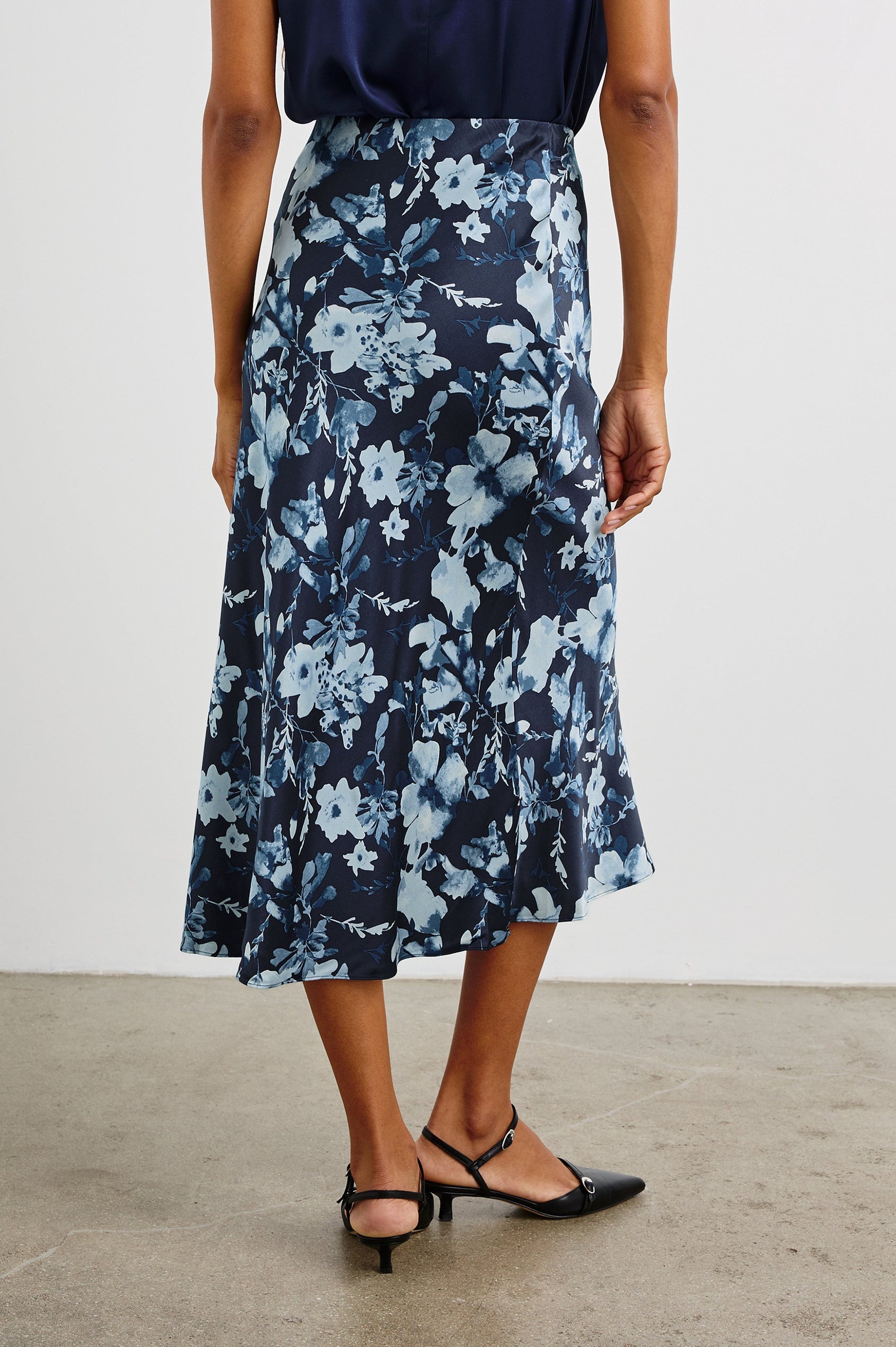 Anya High-waisted Midi Skirt in Indigo Blossoms Colorway, with flowers in Blues on indigo - Back View Featured on Model