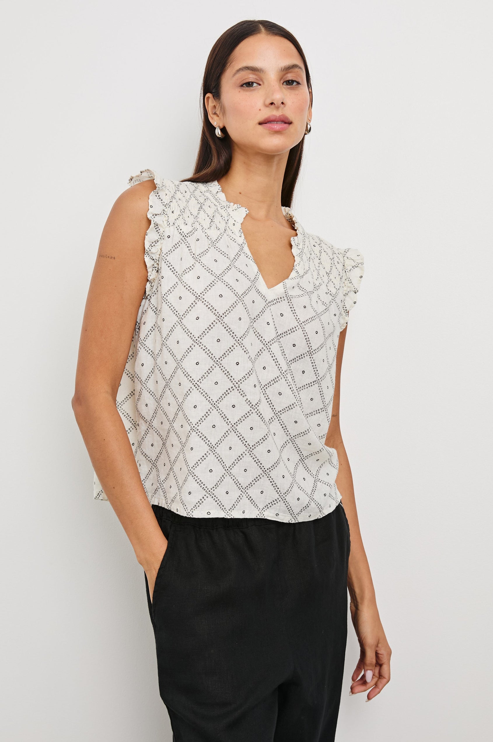 Arlene Top with Short Flutter Cap Sleeves, A V-Neckline and Shirring Along the Top Front in Ivory Zanzibar Colorway, a Dotted Black Grid on Ivory - Front Untucked View Featured on Model