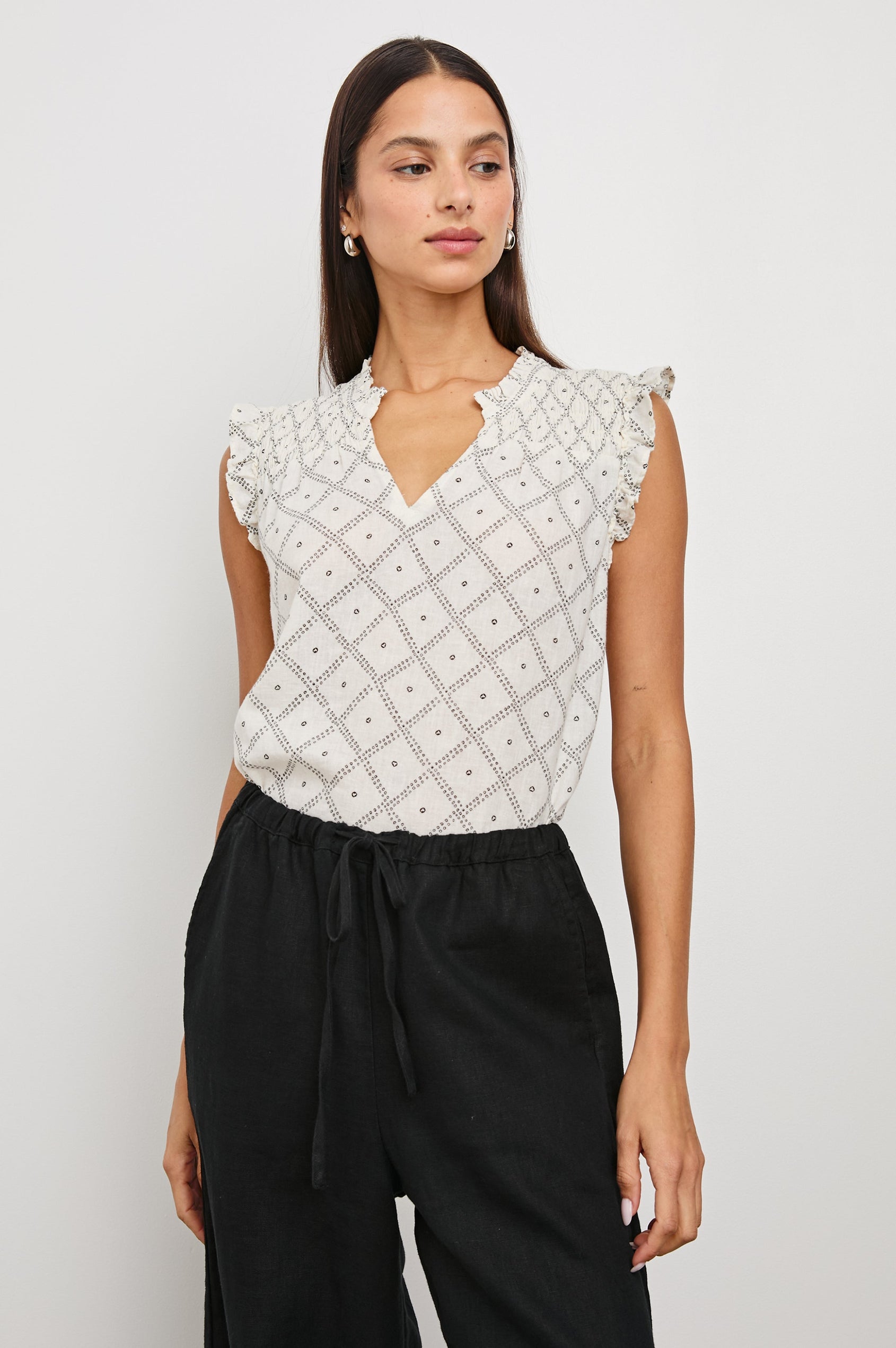 Arlene Top with Short Flutter Cap Sleeves, A V-Neckline and Shirring Along the Top Front in Ivory Zanzibar Colorway, a Dotted Black Grid on Ivory - Front Tucked View Featured on Model
