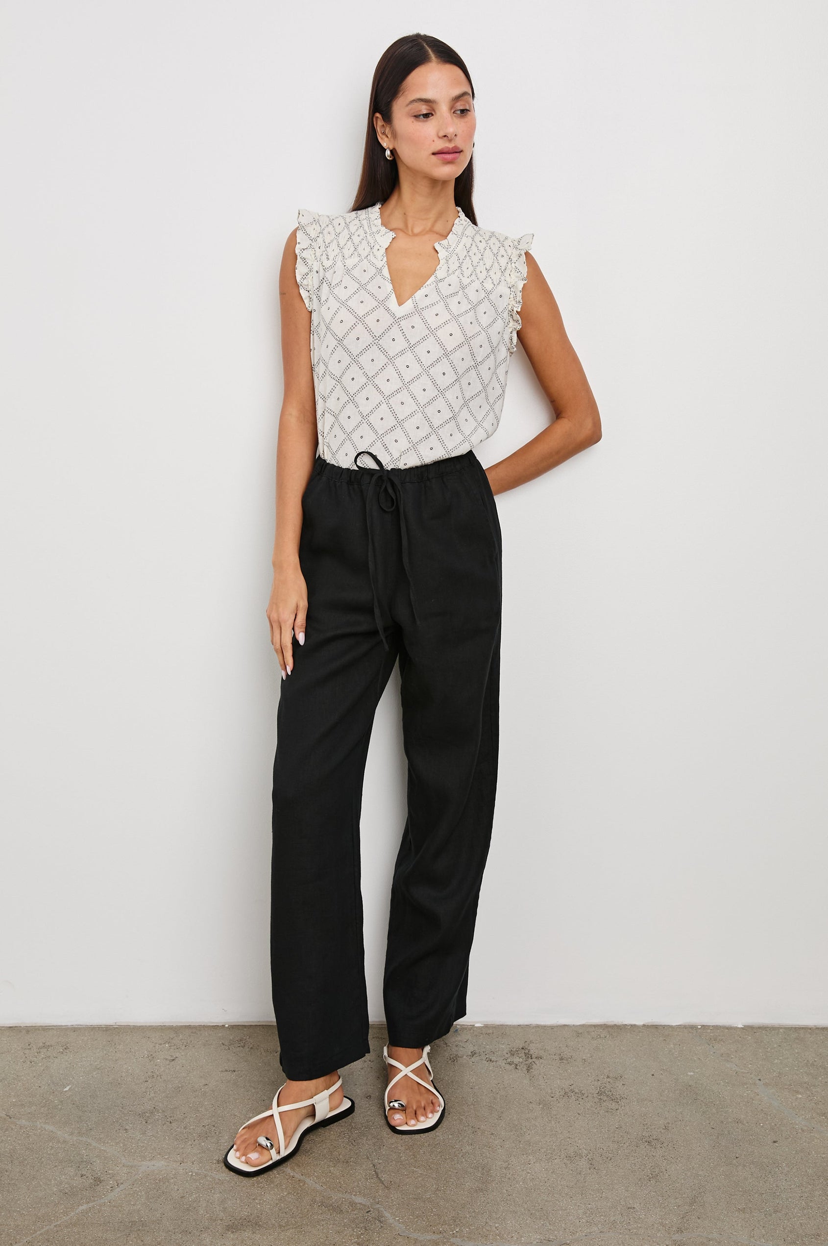 Arlene Top with Short Flutter Cap Sleeves, A V-Neckline and Shirring Along the Top Front in Ivory Zanzibar Colorway, a Dotted Black Grid on Ivory - Front Tucked Full Body View Featured on Model