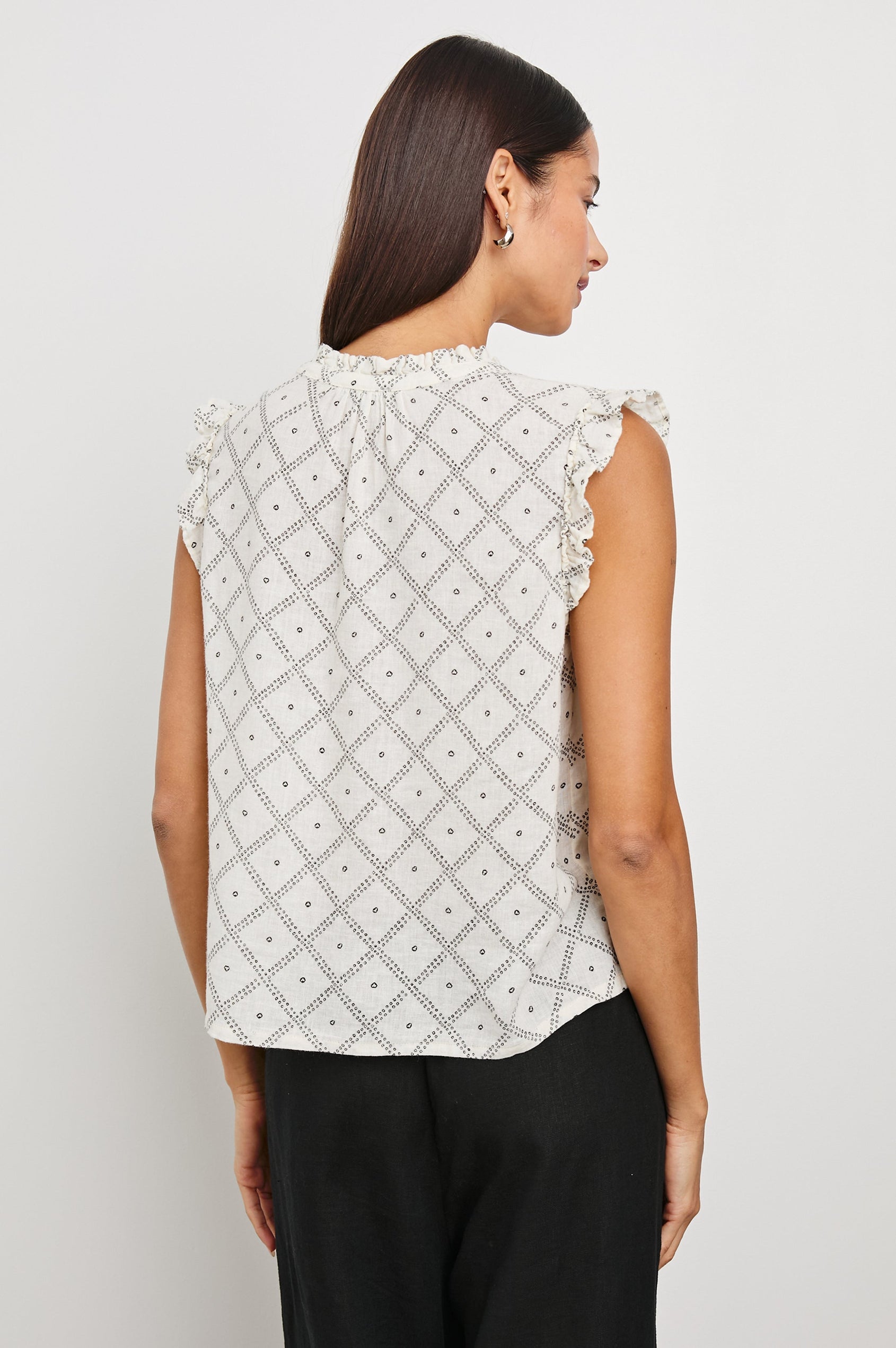 Arlene Top with Short Flutter Cap Sleeves, A V-Neckline and Shirring Along the Top Front in Ivory Zanzibar Colorway, a Dotted Black Grid on Ivory - Back Untucked View Featured on Model
