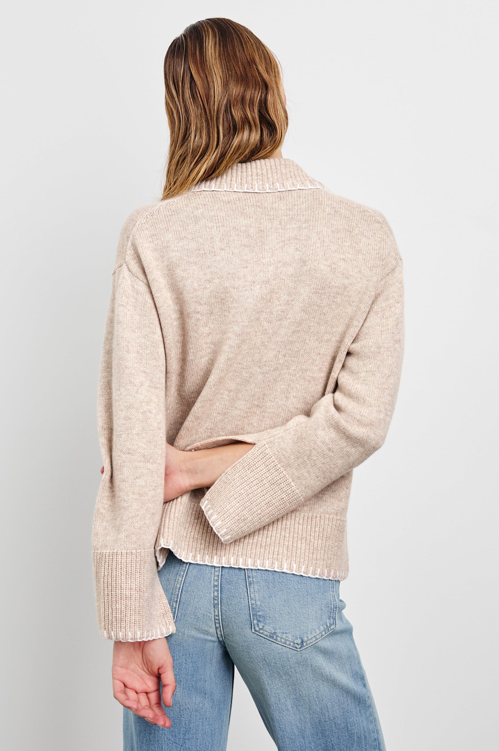 Athena Long-Sleeve Sweater with a Flat Collar V Neckline, Ribbed Cuffs and Hem and Stitching at the Cuffs and Hem in Oat Colorway - Back View Featured on Model