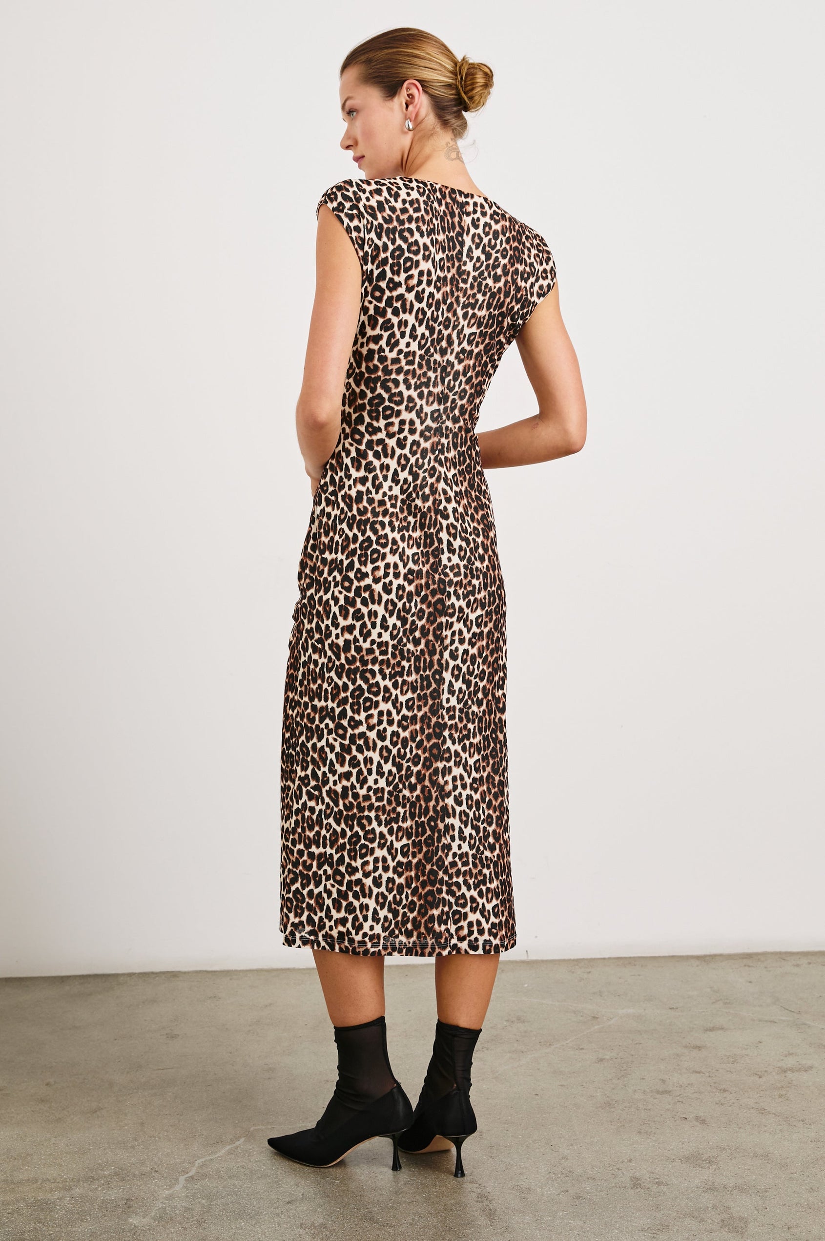 Auren Midi Dress with Cap Sleeves, a Deep V Neck, a Mid-Thigh Side Slit and Ruching from the V Neck to the Slit with a Drawcord at the Slit in Nala Colorway, Black and Brown Spots on Tan - Back Full Body View Featured on Model