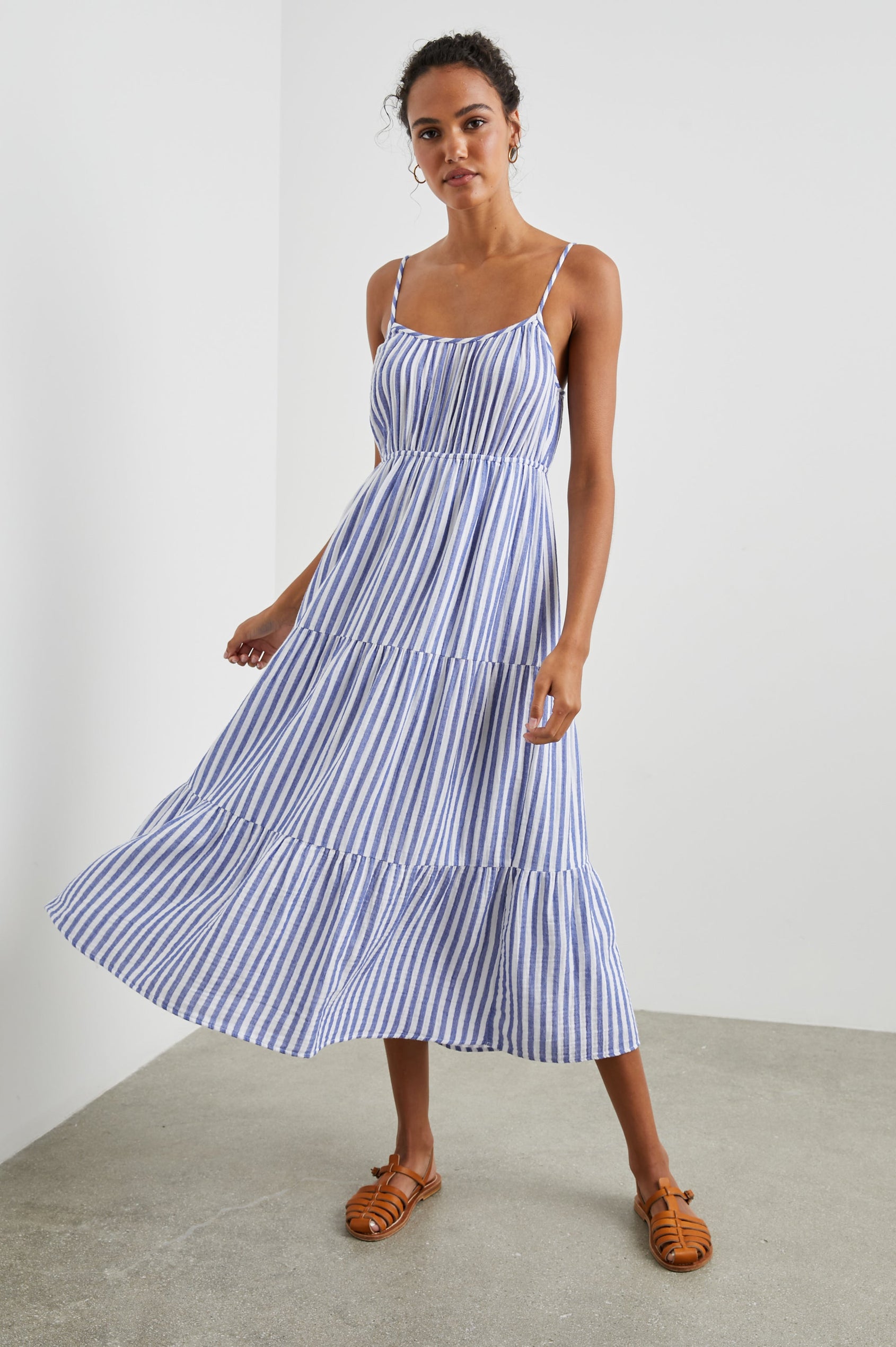 Blakely Sleeveless Tiered Midi Dress with Adjustable Spaghetti Straps and a Scoop Neck in Anacapa Stripe Colorway, Blue and White Vertical Stripes - Front Full Body View Featured on Model