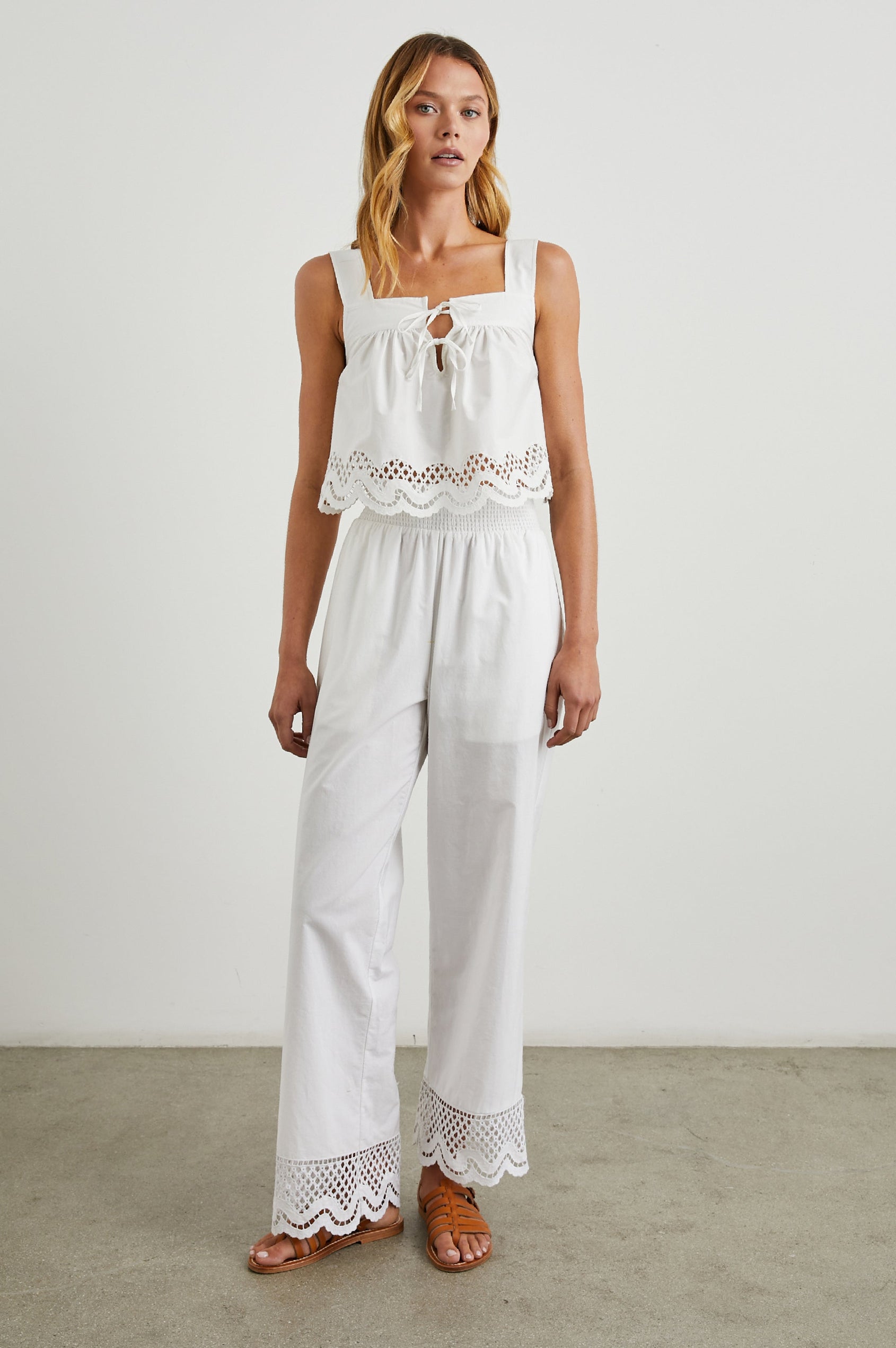 Blythe Crop Tank Top with a Deep Neck with Ties and a Scalloped Hem with Eyelet Embroidery in White Colorway - Front Full Body View Featured on Model