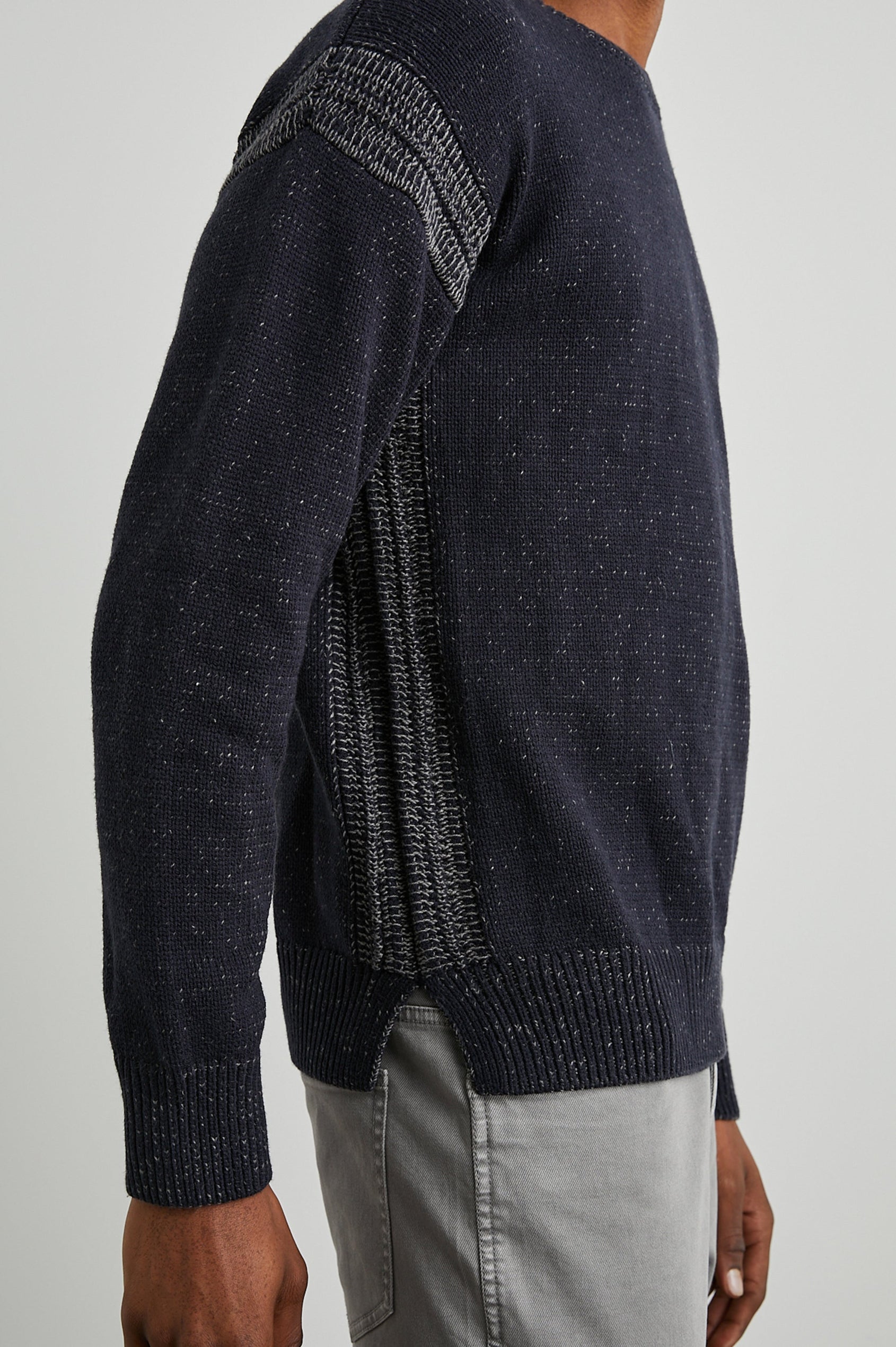 Bryce Long-Sleeve Sweater with a Crew Neck, Ribbed Trim in Navy Colorway, with White Speckles and Stitching at Shoulder Seams - Side View Featured on Model