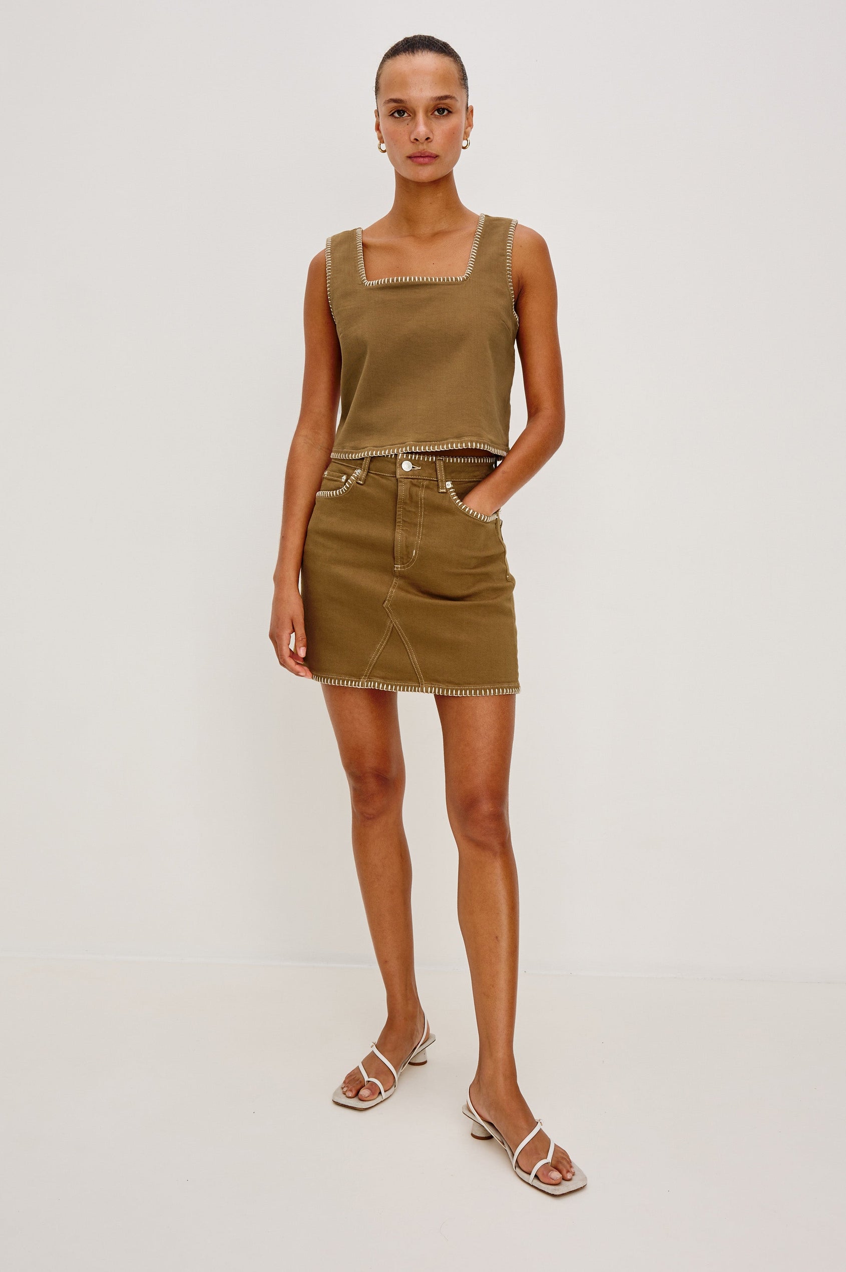 Carbon Denim Tank Top with Wide Straps, Square Neckline and Blanket Stitching on Edges in Safari Embroidered Colorway. Full Body Front View on Model Shown.