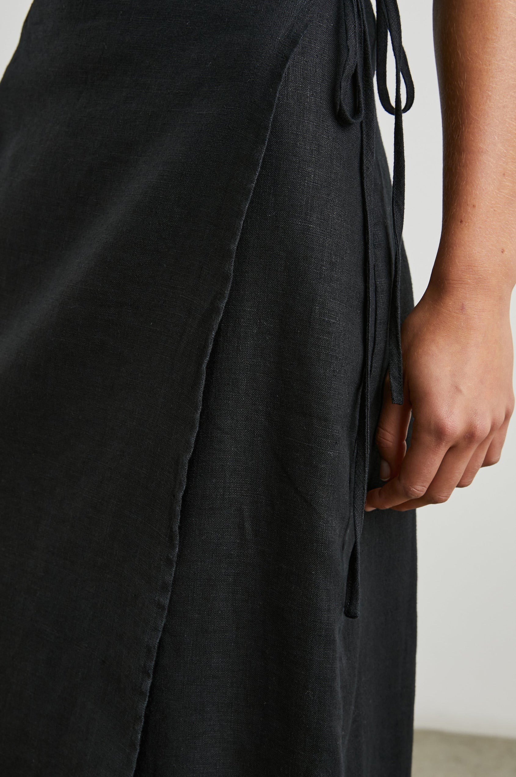 Carly Midi Wrap Skirt With a Side Tie in Black Colorway - Front View Featured on Model