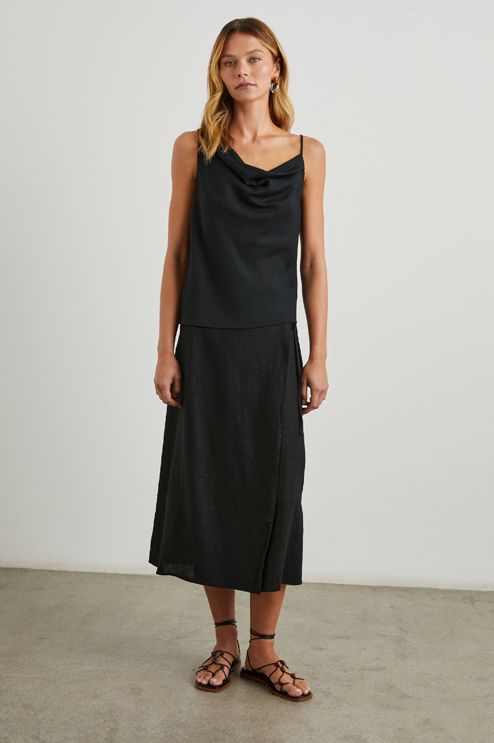 Carly Midi Wrap Skirt With a Side Tie in Black Colorway - Front Full Body View Featured on Model