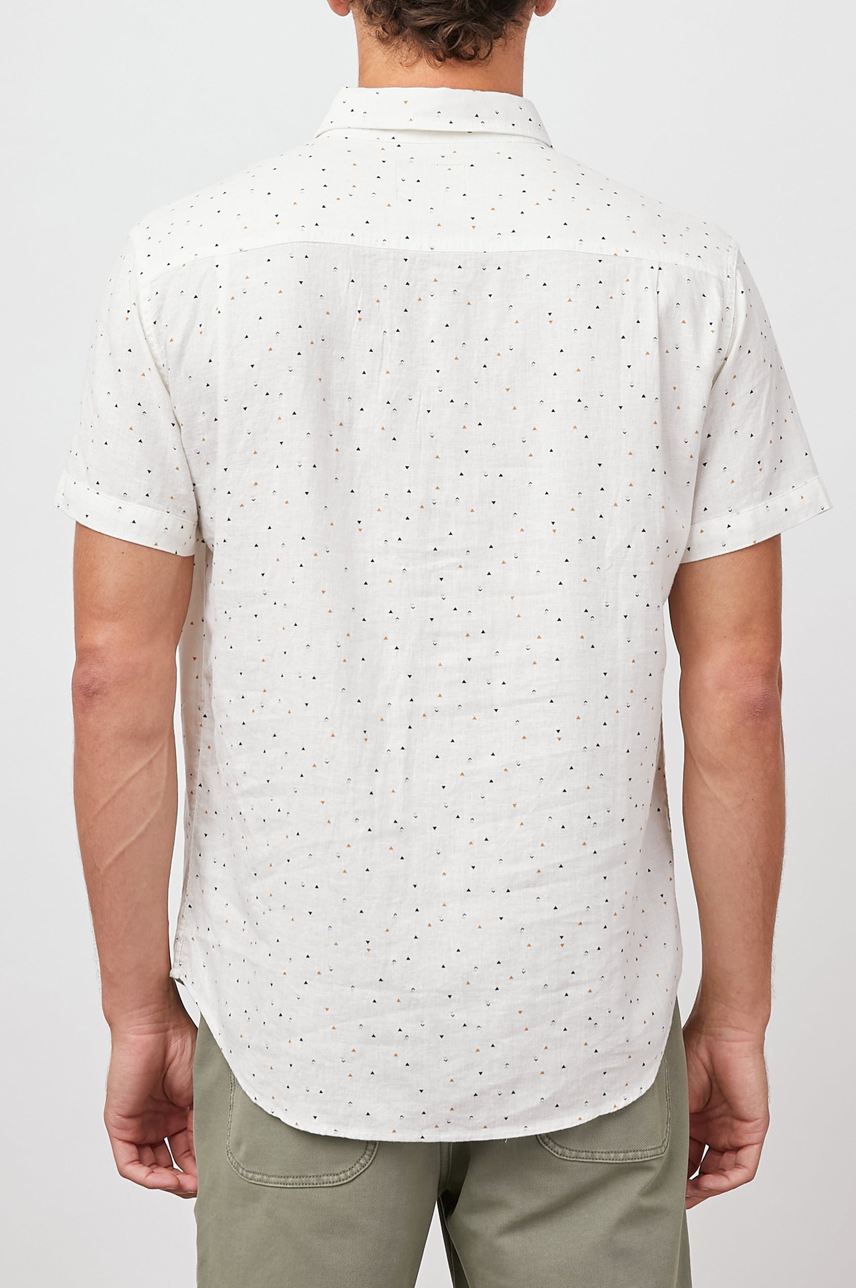 Carson Short Sleeve Button Up with a Chest Patch Pocket in Triangle Geo Colorway, Small Tan, Grey and Black Triangles on White - Back View Featured on Model