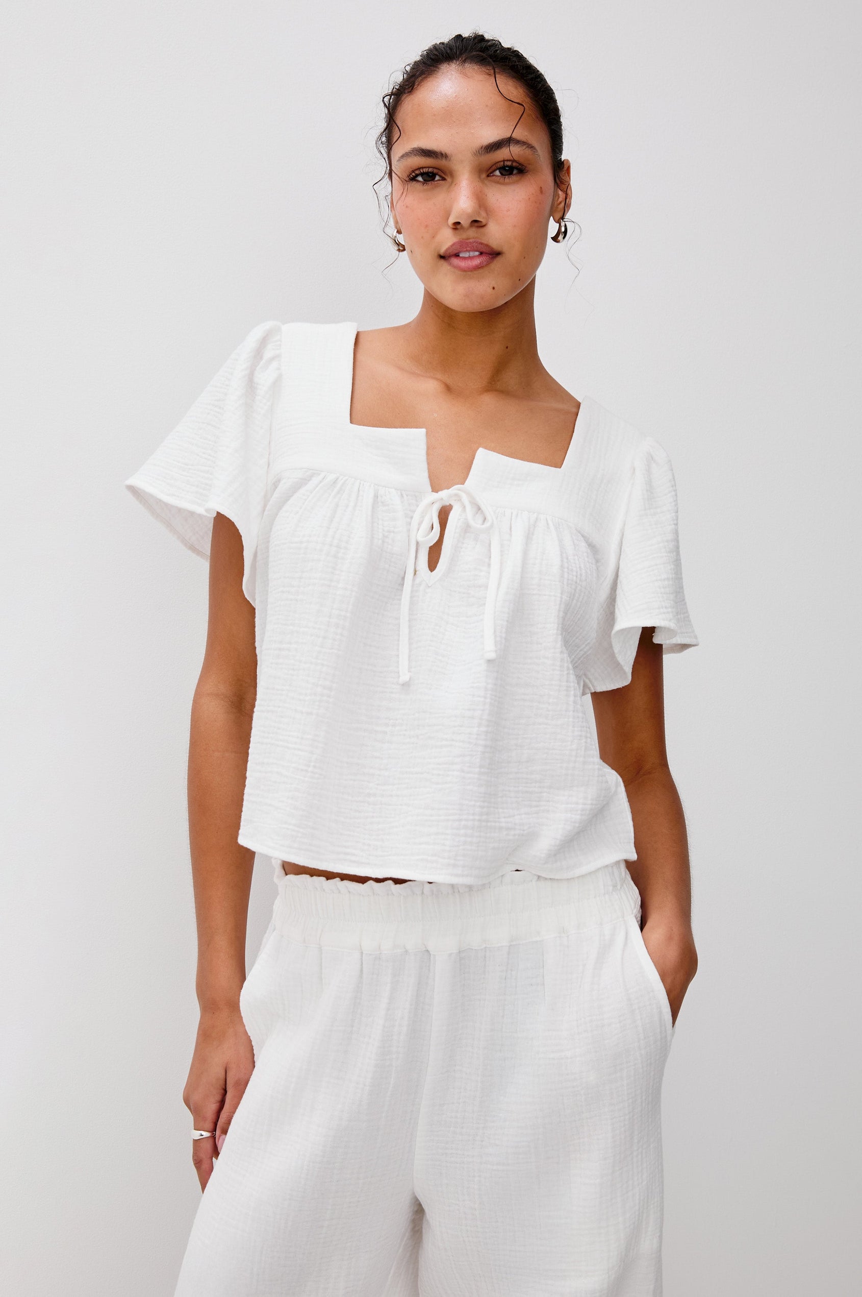 Casie Square Neck Flutter Sleeve Top with a V-Tie Front in White Colorway. Front View Shown on Model.