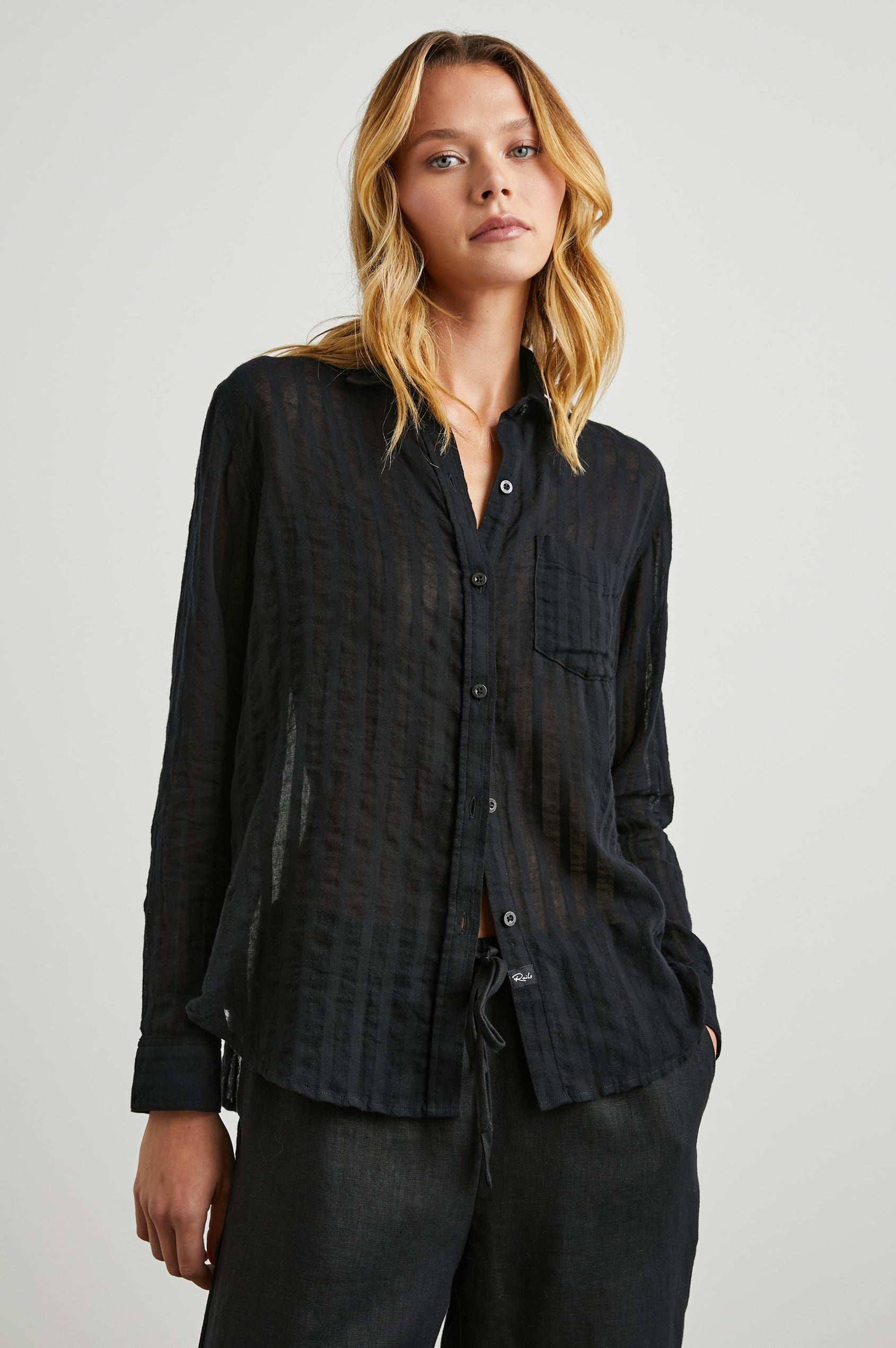 Charli Long-Sleeve Button up with a Chest Patch Pocket in Black Shadow Stripe Colorway, with Vertical Solid and Gauzy Black Stripes - Front View Featured on Model