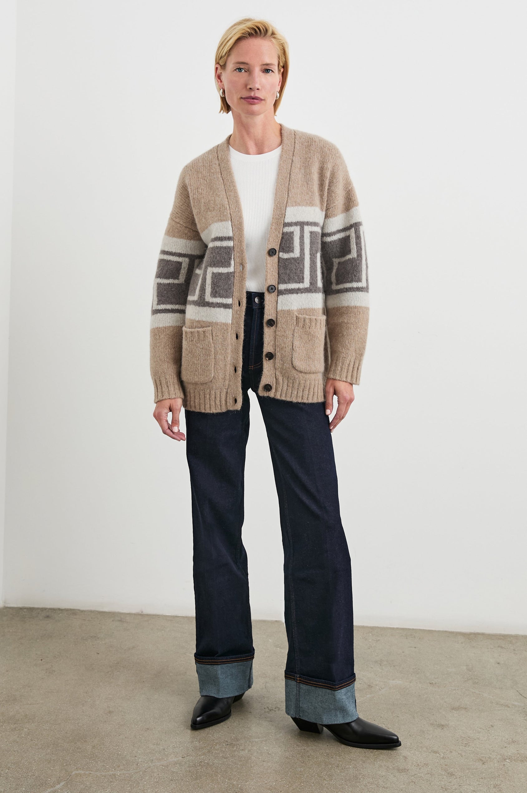 Chelsea Long-Sleeve Cardigan with Button Closure, Two Front Patch Pockets, Ribbed Trim and a Deep V Neck in Aspen Trail Colorway, a Grey and White Geometric Pattern on Oatmeal - Front Full Body View Featured on Model