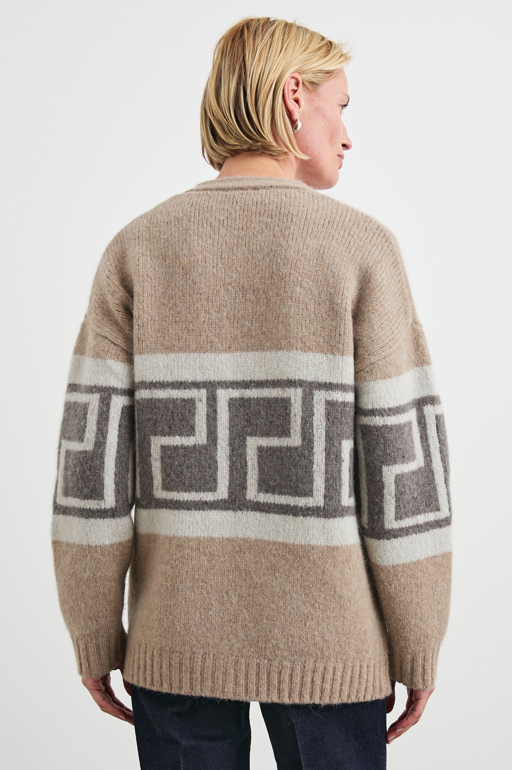 Chelsea Long-Sleeve Cardigan with Button Closure, Two Front Patch Pockets, Ribbed Trim and a Deep V Neck in Aspen Trail Colorway, a Grey and White Geometric Pattern on Oatmeal - Back View Featured on Model