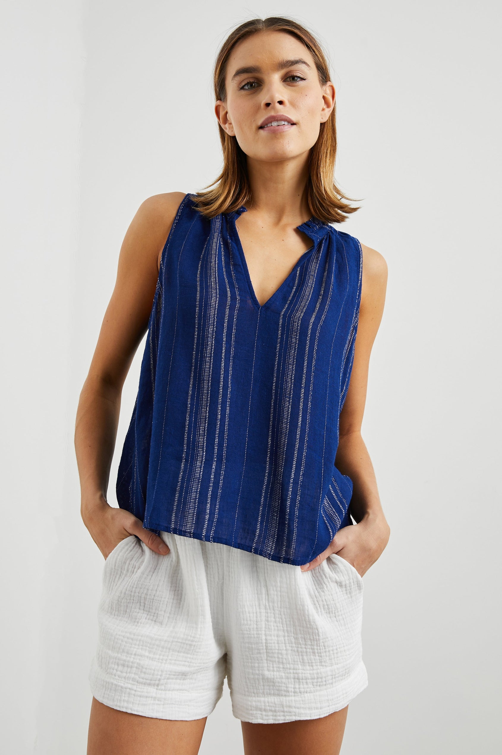 Christy Sleeveless Tank Top, with a V Neck and a Ruched Collar in Papaya Stripe Colorway, Vertical Stripes in Orange, Pink, Purple and Cream - Front View Featured on Model