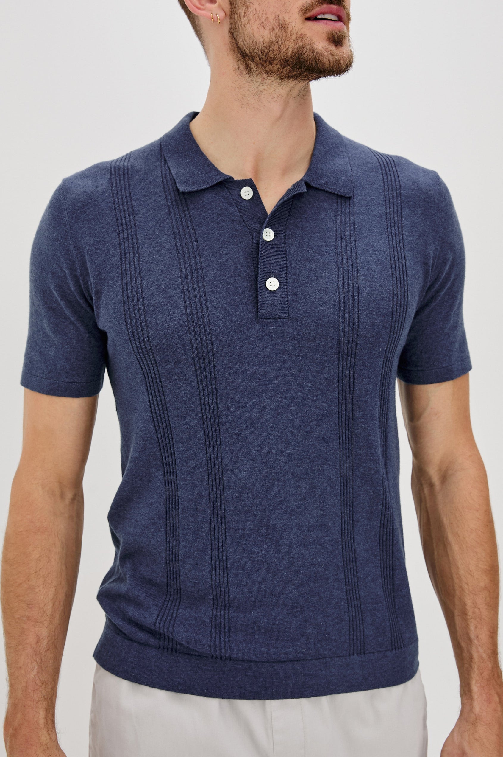 Cillian short sleeve cotton silk blend polo with three button placket and retro  front stripe details in Indigo Denim - front detail view on model