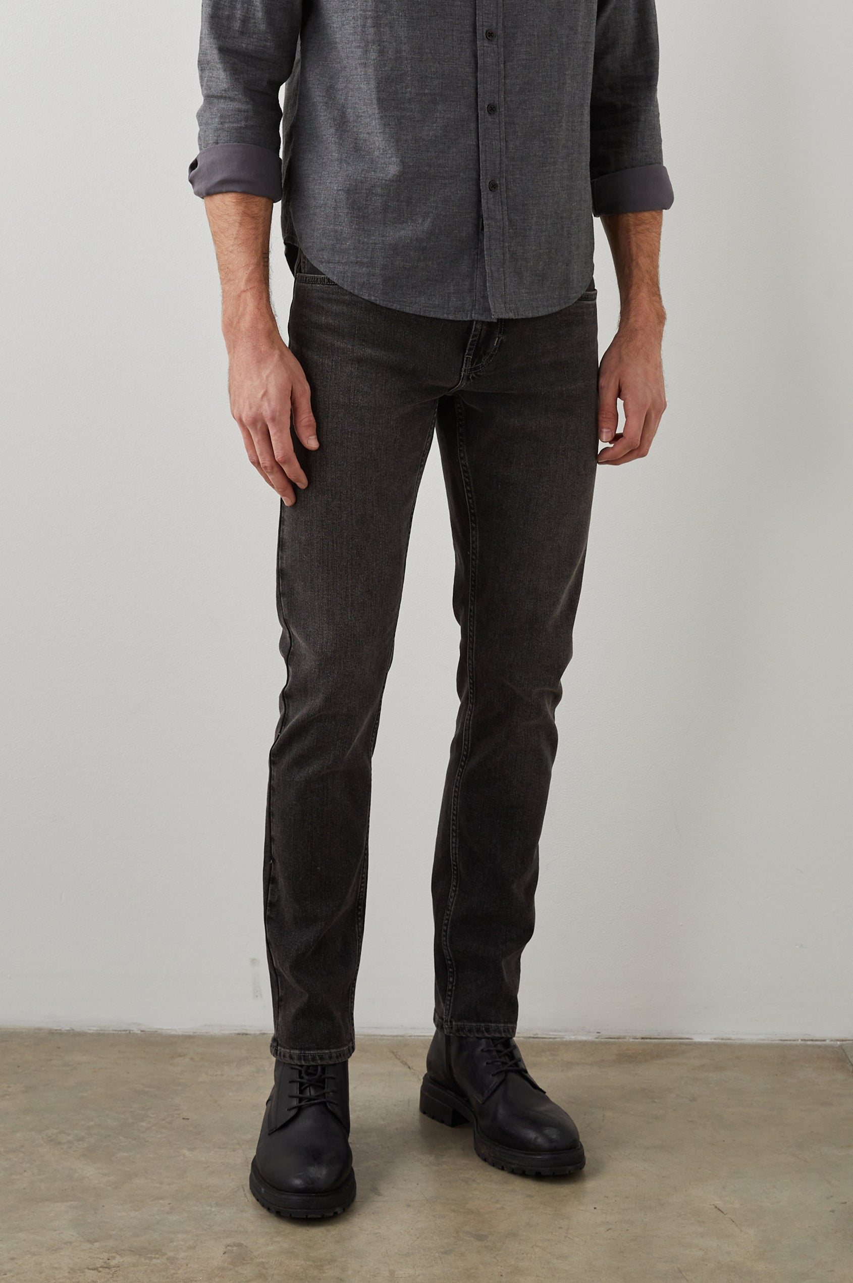 Clayton Slim Straight Jeans with Belt Loops, Two Front Pockets plus a Coin Pocket and Two Back Patch Pockets in Reever 5 Year Colorway, a Washed Black - Front View Featured on Model