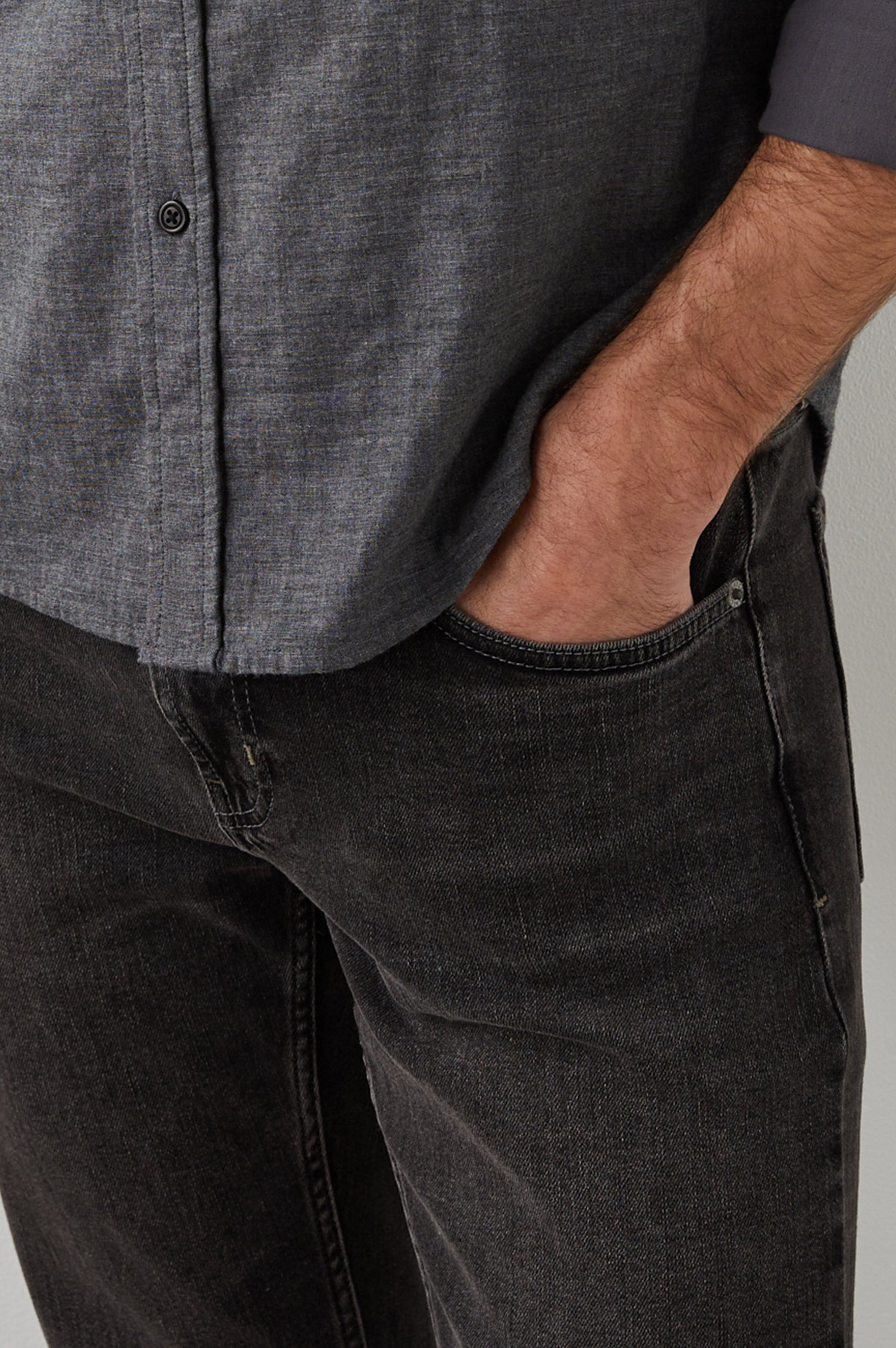 Clayton Slim Straight Jeans with Belt Loops, Two Front Pockets plus a Coin Pocket and Two Back Patch Pockets in Reever 5 Year Colorway, a Washed Black - Front View Featured on Model