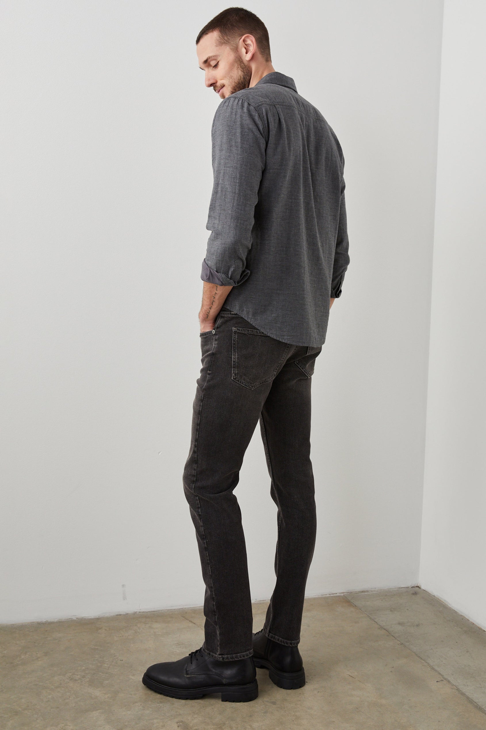 Clayton Slim Straight Jeans with Belt Loops, Two Front Pockets plus a Coin Pocket and Two Back Patch Pockets in Reever 5 Year Colorway, a Washed Black - Back Full Body View Featured on Model