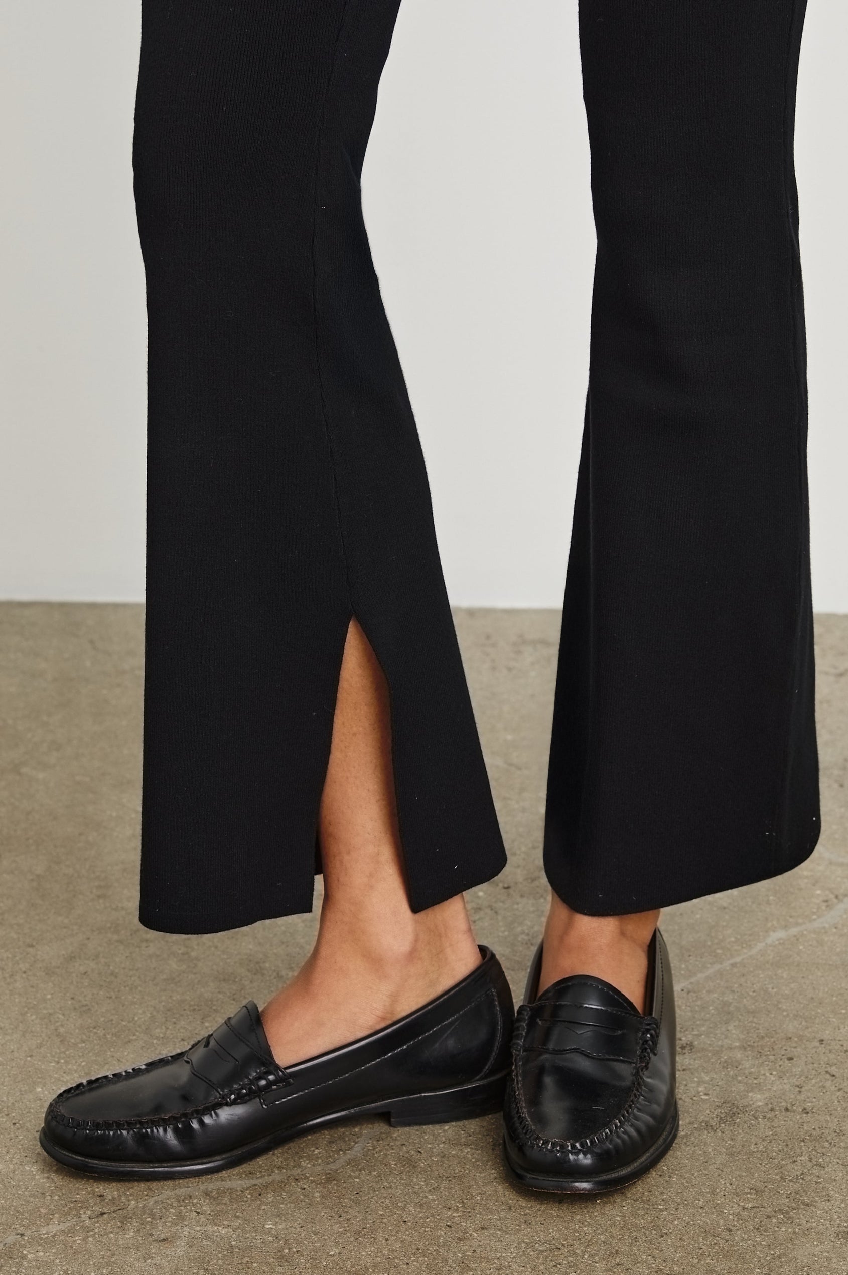 Cleo Sweatpant With A Wide Leg and Slit At Bottom Hem In Black - Hem Detail Featured On Model