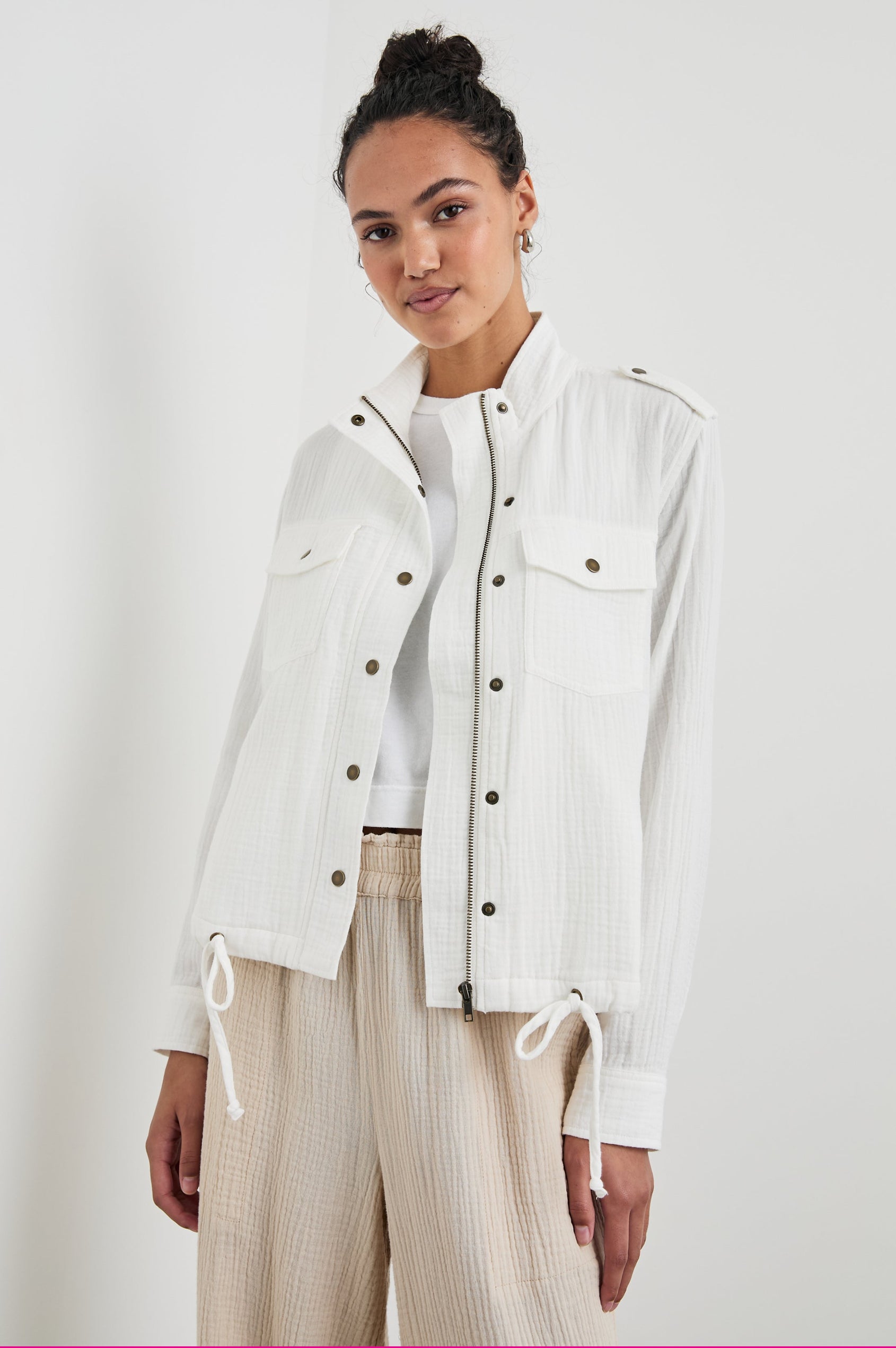 Collins Jacket with Zip and Snap Closure, Two Chest Snap Flap Pockets, Toggle Drawstring Hem, Snap Shoulder Straps and a Breathable Back Flap in Gauze White Colorway - Front View Featured on Model