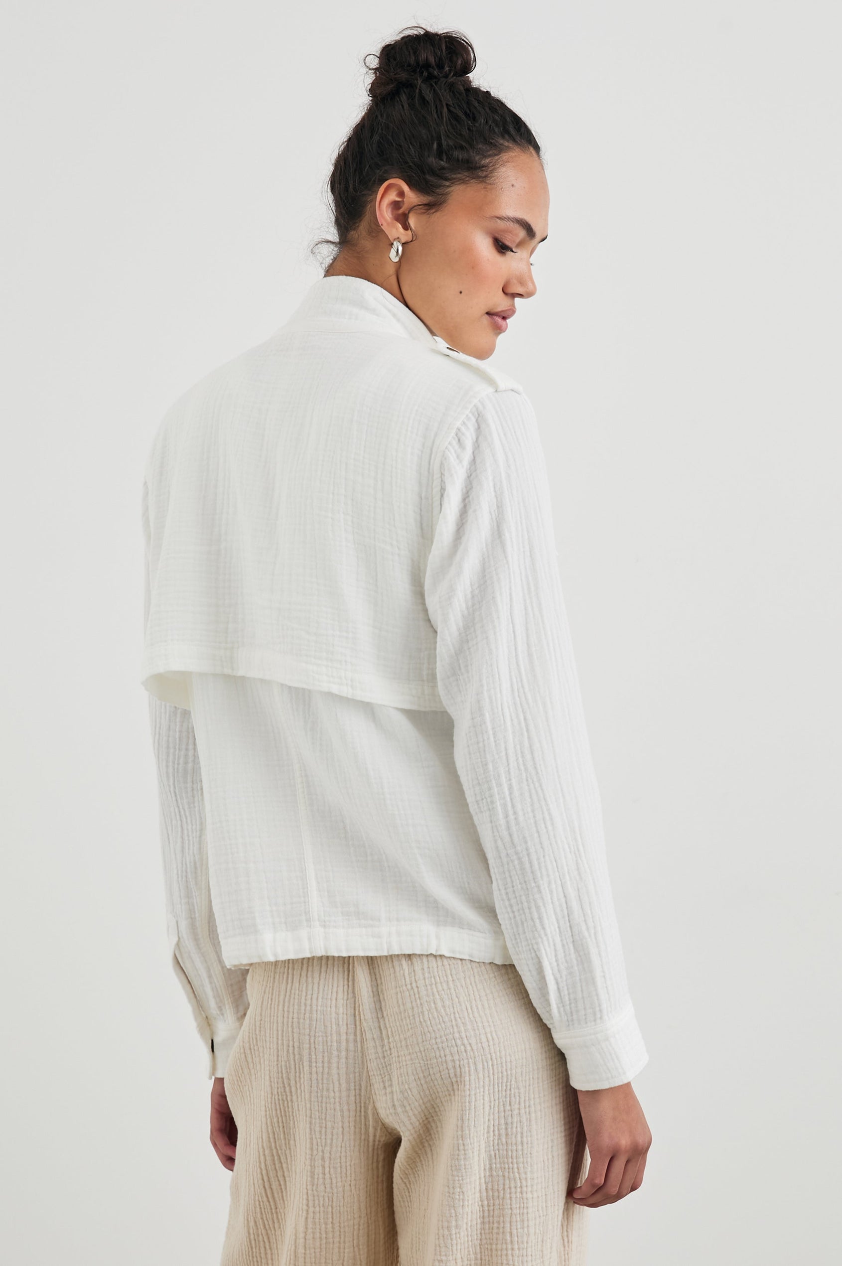 Collins Jacket with Zip and Snap Closure, Two Chest Snap Flap Pockets, Toggle Drawstring Hem, Snap Shoulder Straps and a Breathable Back Flap in Gauze White Colorway - Back View Featured on Model