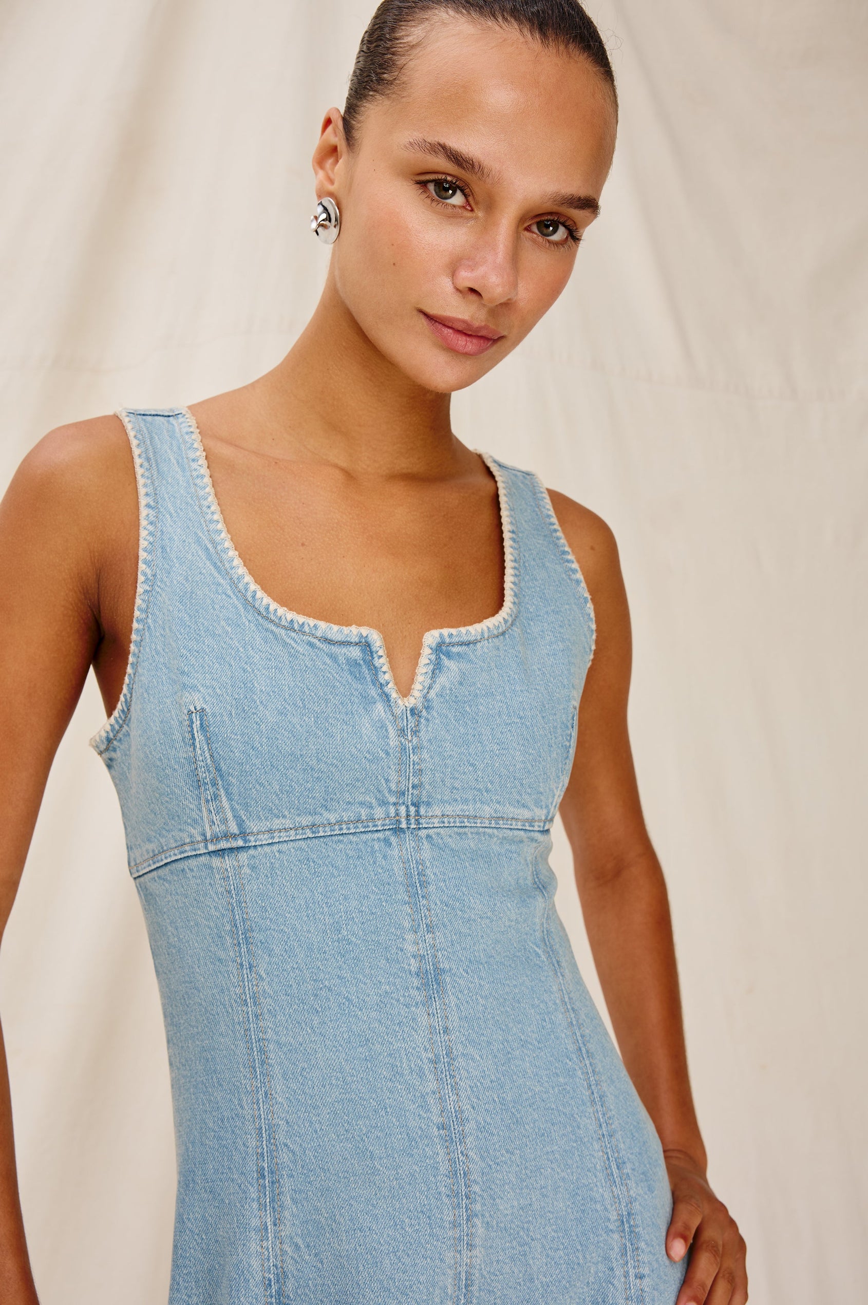 Cove Denim Tank Dress with a Scoop Split neck, Empire Bust, A-line and Above-Knee Length in Capri Colorway. Front Detailed View Shown on Model.