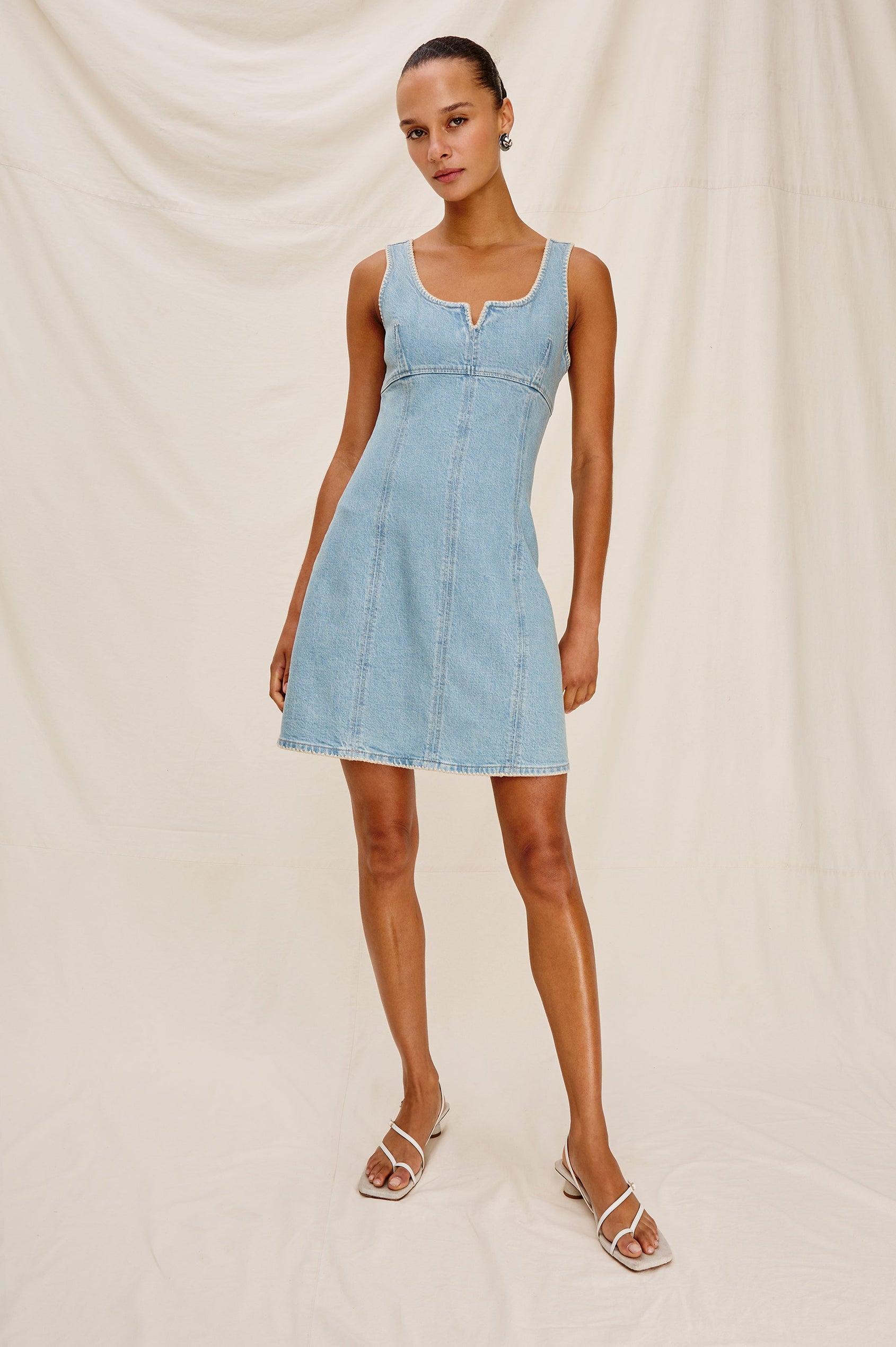 Cove Denim Tank Dress with a Scoop Split neck, Empire Bust, A-line and Above-Knee Length in Capri Colorway. Full Body Front View Shown on Model.
