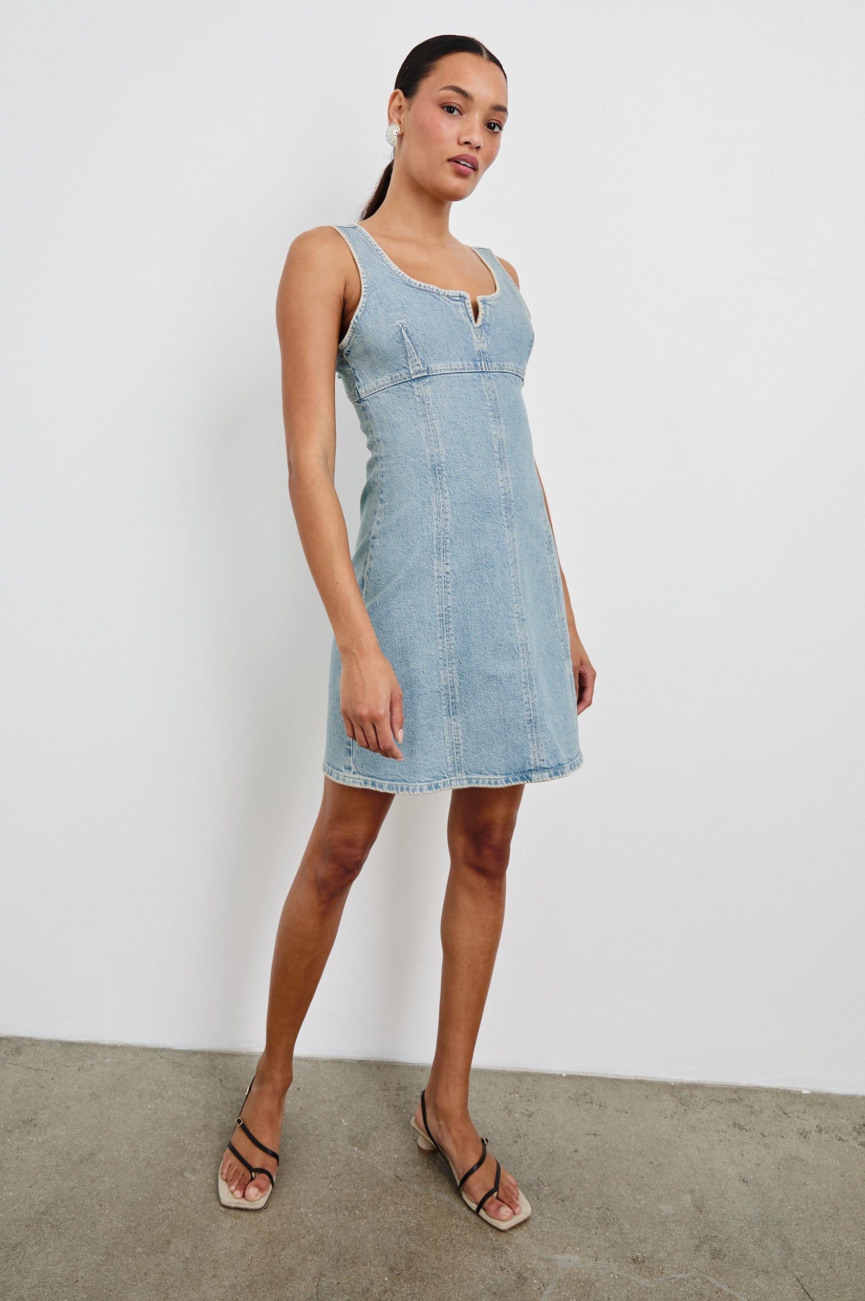 Cove Denim Tank Dress with a Scoop Split neck, Empire Bust, A-line and Above-Knee Length in Capri Colorway. Full Body Front View Shown on Model.