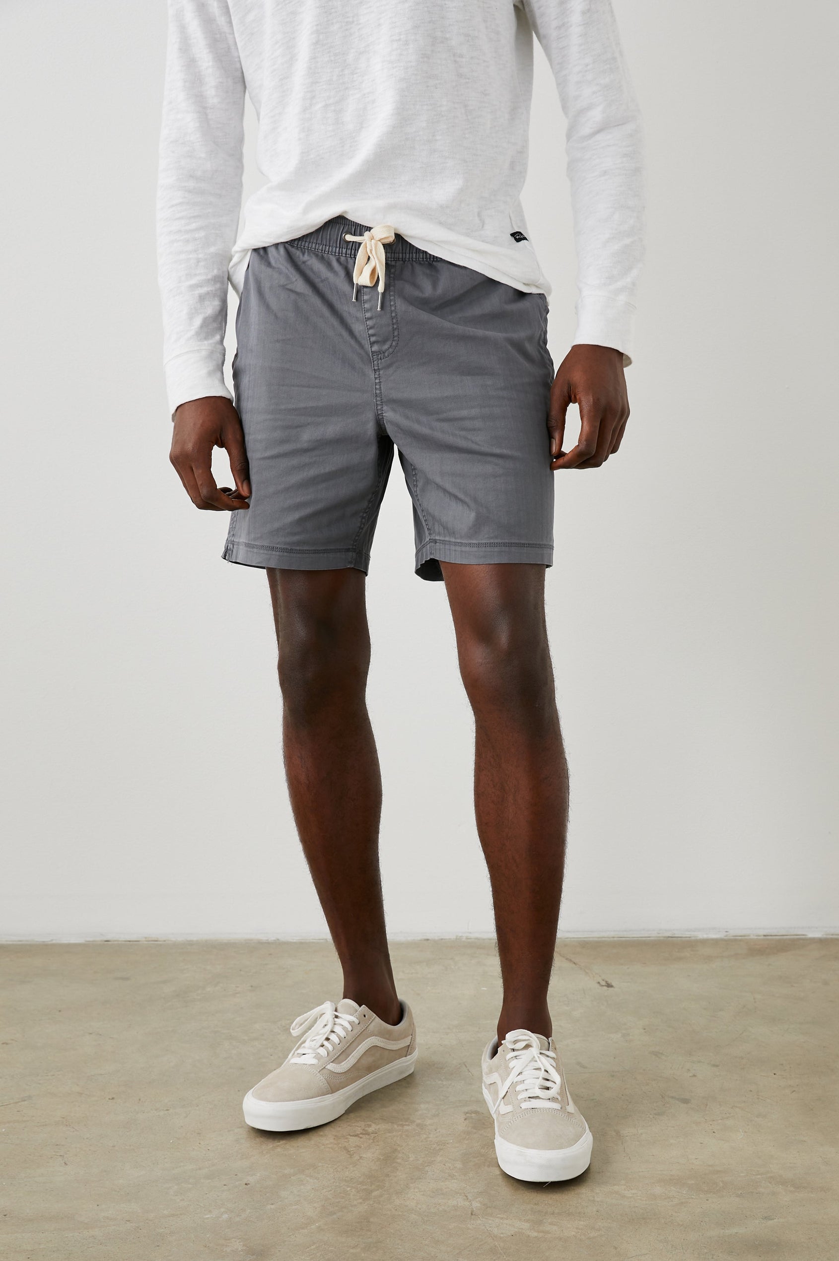 Cruz Shorts with a Drawstring Waist, Two Front Pockets, Two Back Button Flap Pockets in Charcoal Colorway - Front View Featured on Model