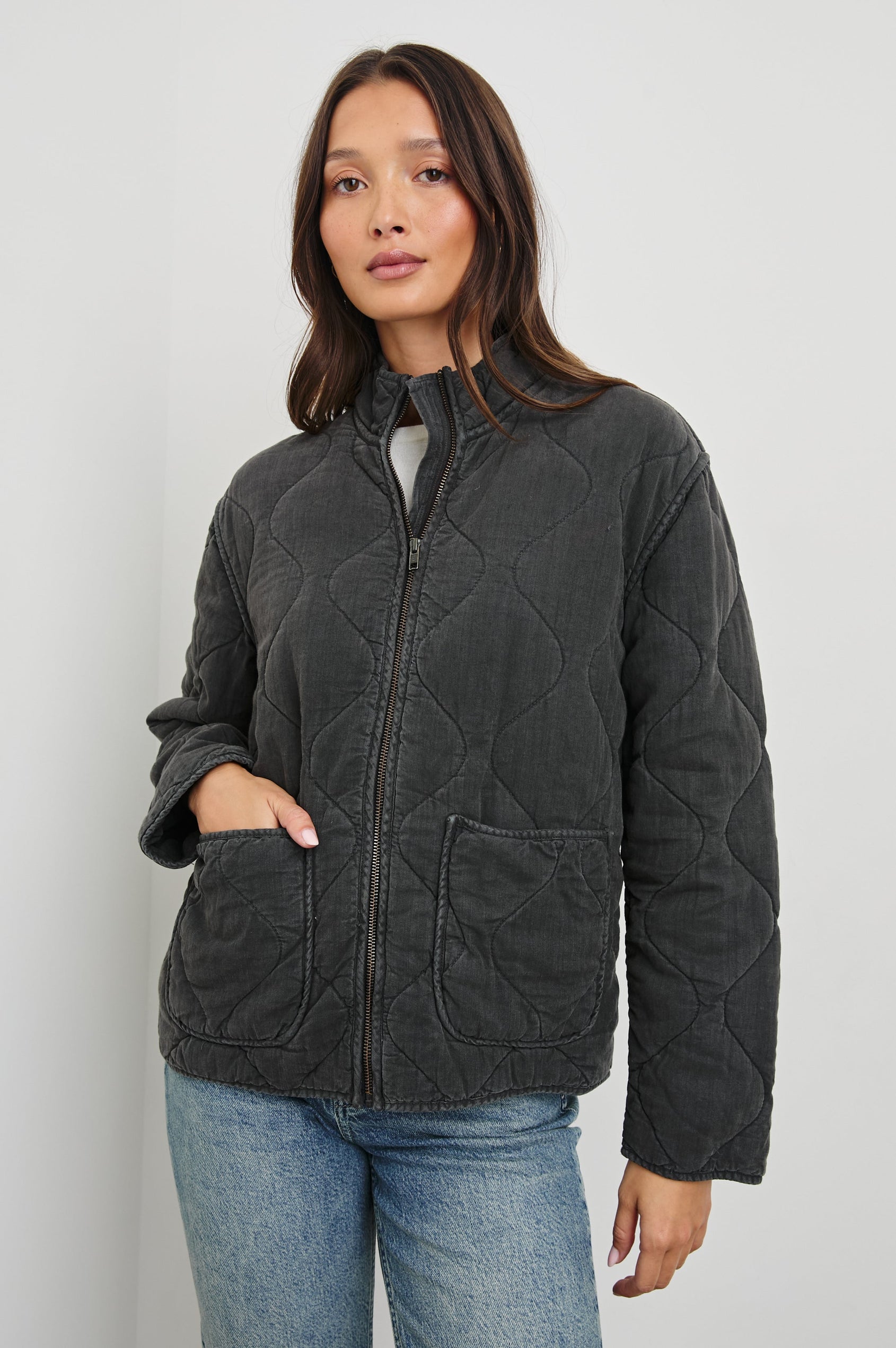 Denver Jacket with a Zip Up Closure, Two Front Patch Pockets and Quilted Stitching in Faded Black Colorway - Front View Featured on Model
