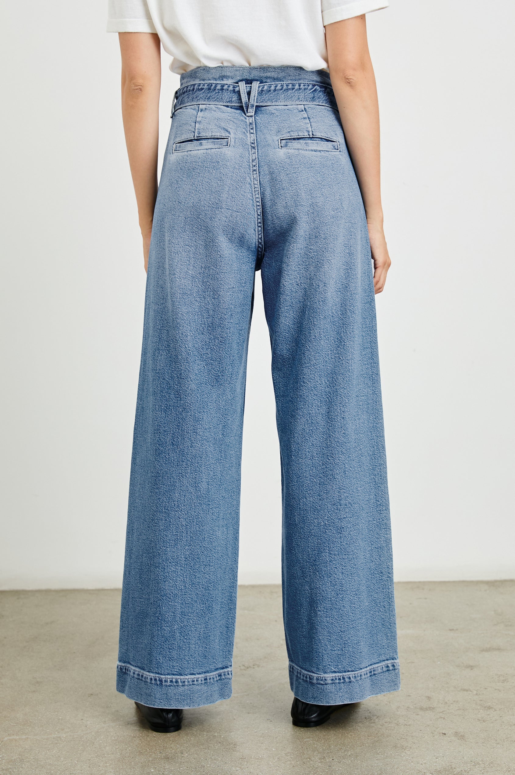 Descanso Wide Leg Denim Pants with Belt Loops, a Fabric O-Ring Belt, Two Front Pockets Plus a Coin Pocket and Two Back Patch Pockets in Cadet Blue Colorway - Back View Featured on Model