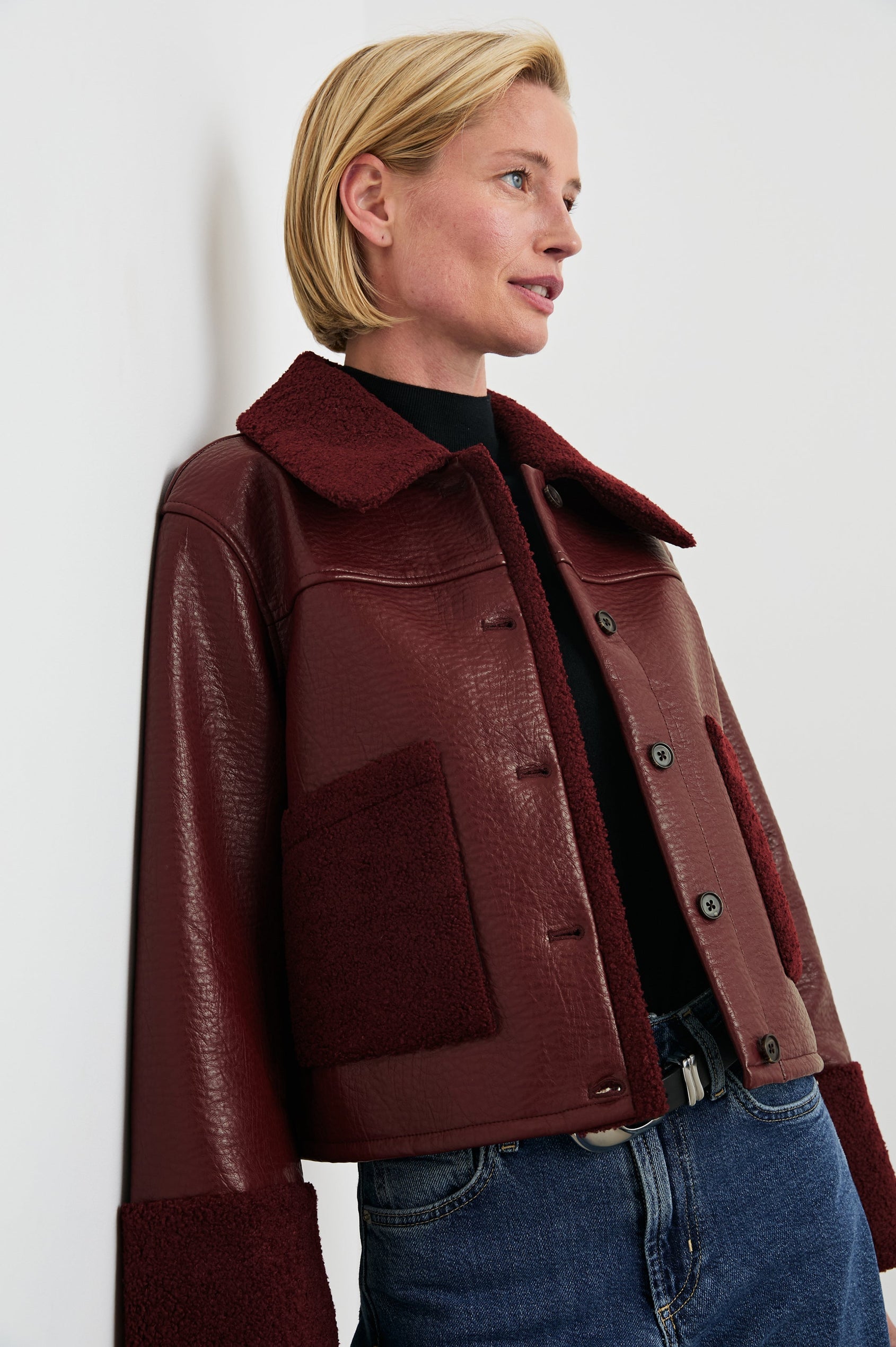 Dria Jacket with Button Closure, Two Front Patch Pockets and Faux Shearling at the Pockets, Cuffs, Collar and Opening in Maroon Shearling Colorway, Front View Featured on Model