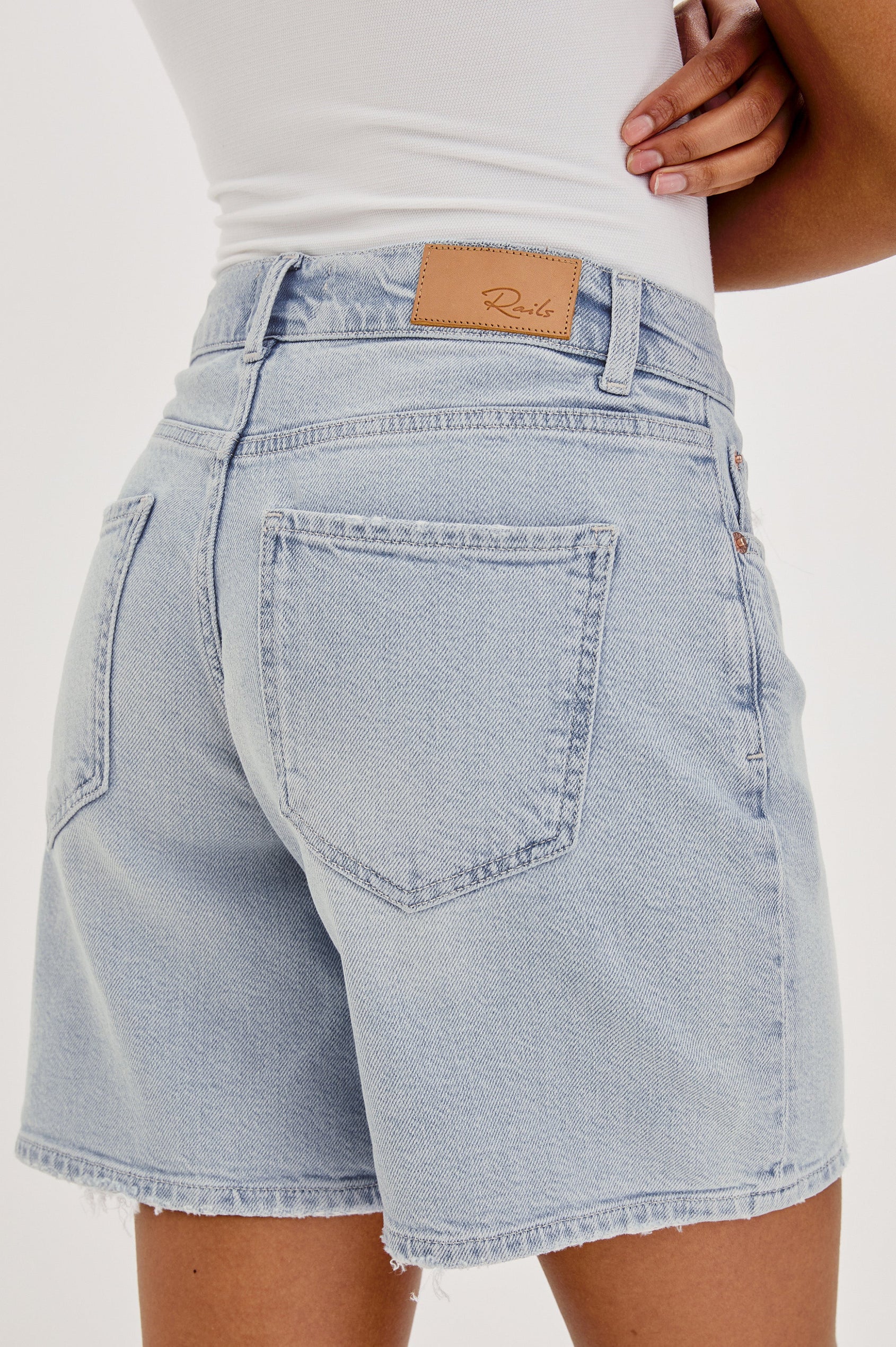 Dume Denim Short, Five Pocket, Zip Fly, Mid-Thigh Length with a White Drawstring Tie Waist in Light Wash Scuba Colorway. Back View Shown on Model.