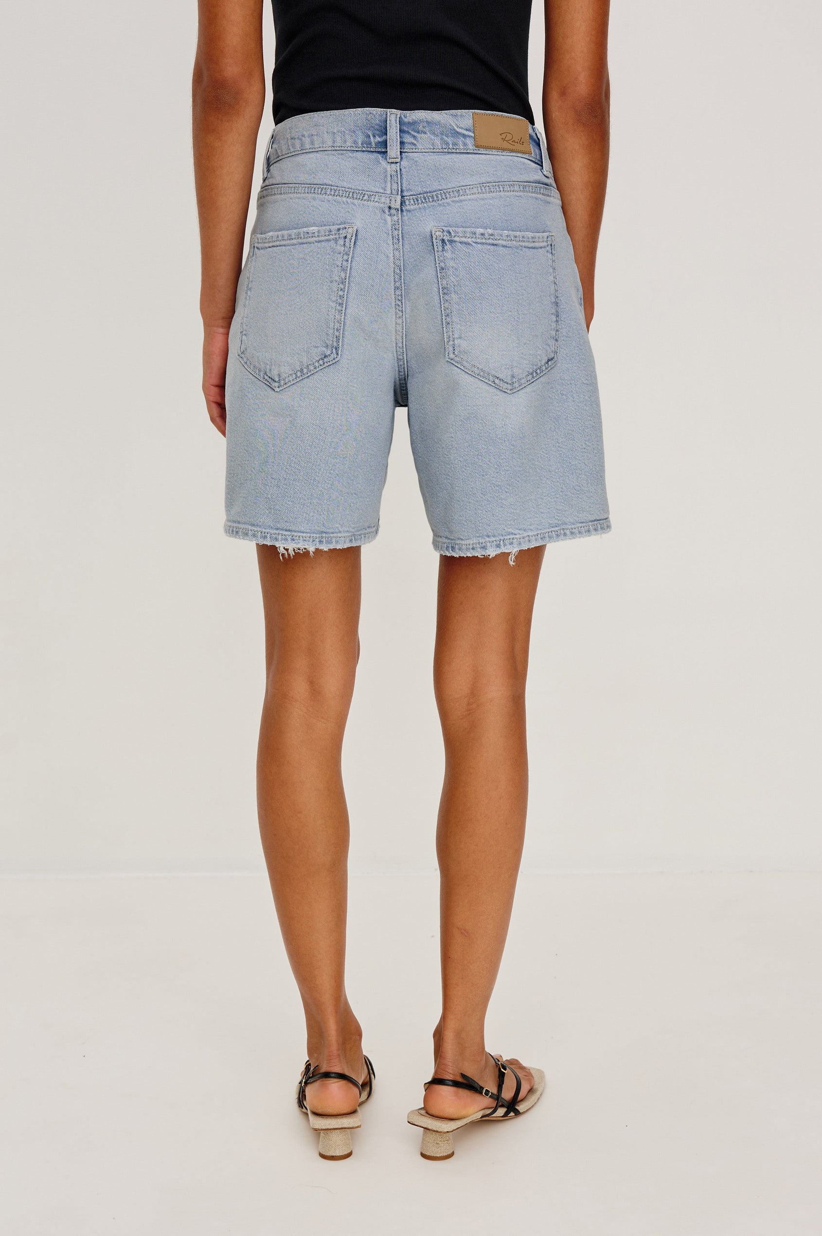 Dume Denim Short, Five Pocket, Zip Fly, Mid-Thigh Length with a White Drawstring Tie Waist in Light Wash Scuba Colorway. Back View Shown on Model.