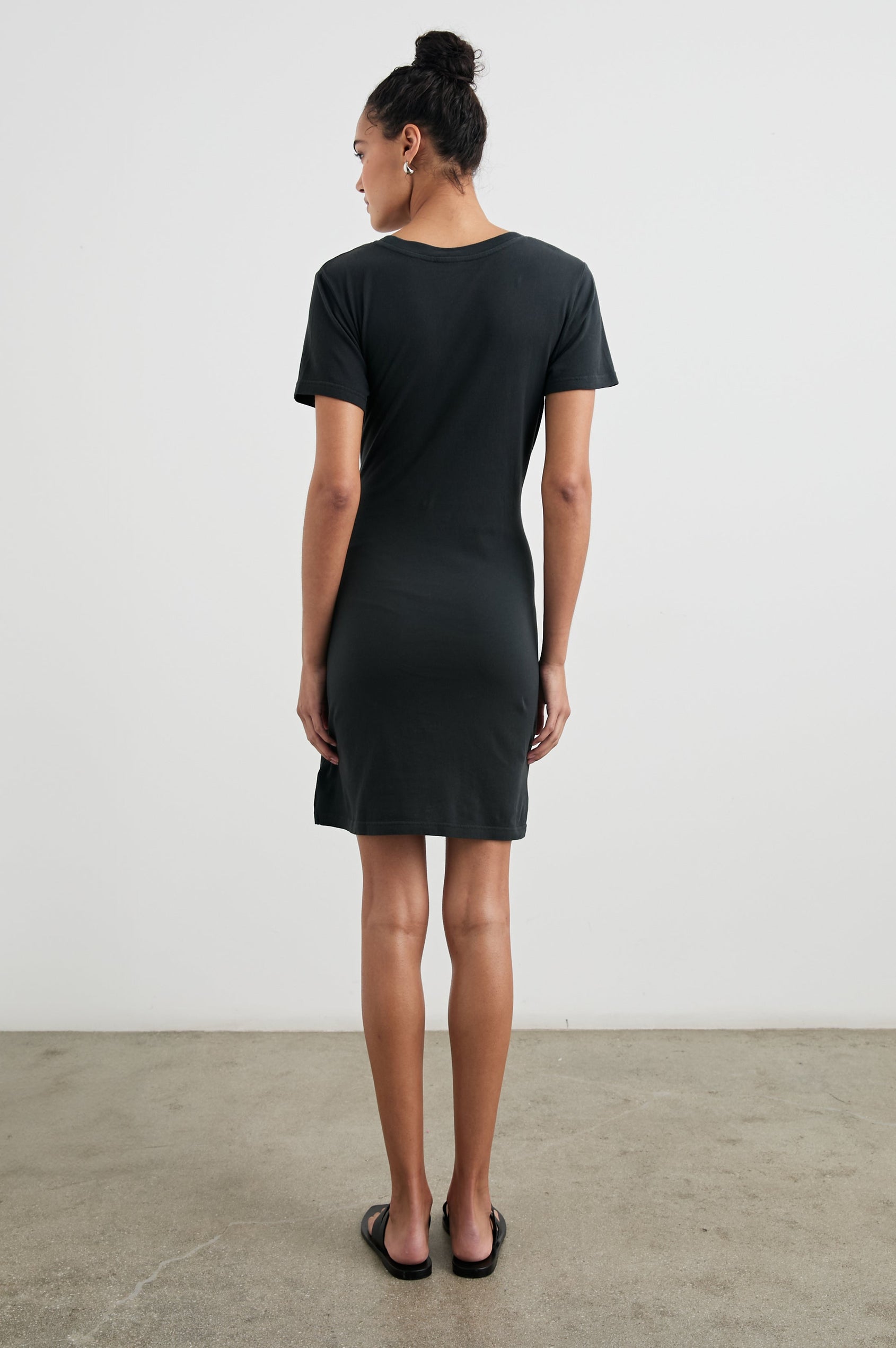 Edie Above-Knee Dress with Short Sleeves, Crew Neckline and Adjustable Wrap Tie At Waist in Vintage Black Colorway - Back Full Body View Featured on Model