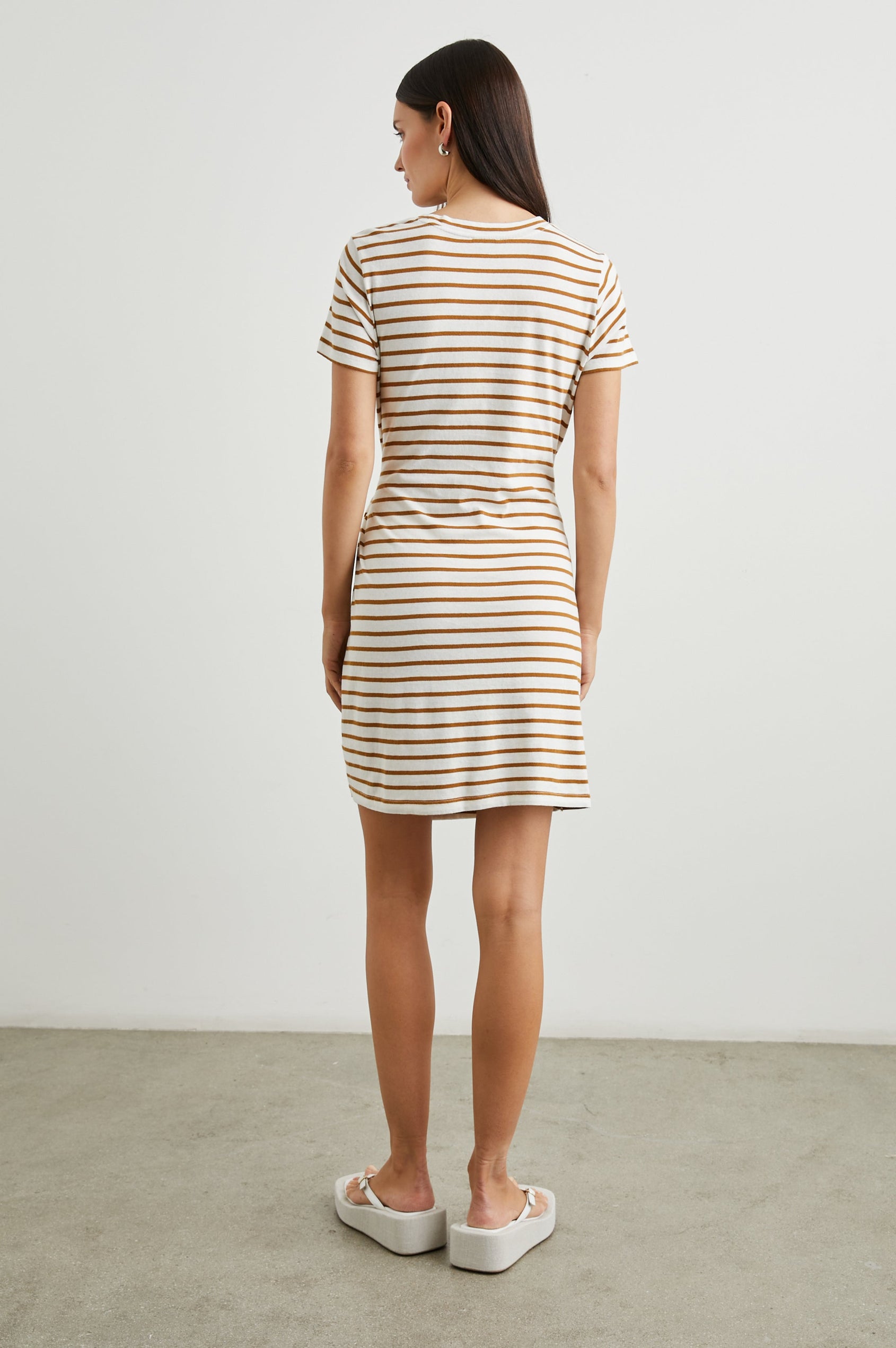 Edie Above-Knee Dress with Short Sleeves, Crew Neckline and Adjustable Wrap Tie At Waist in Carmel Stripe Colorway, Horizontal Carmel and Ivory Stripes - Back Full Body View Featured on Model