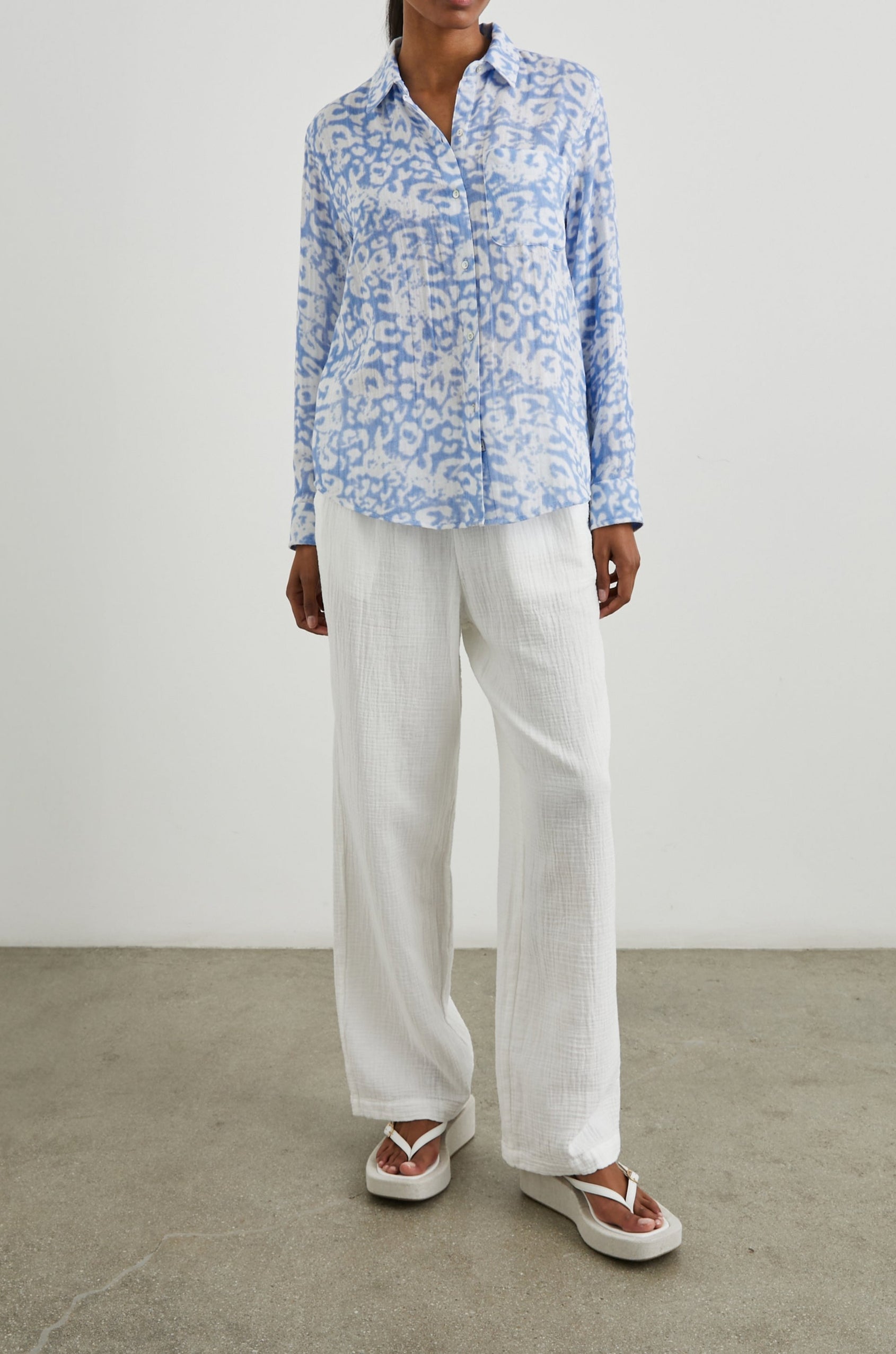 Ellis Long-Sleeve Button Down with Cuffs and a Chest Pocket in Blue Diffused Cheetah Colorway, with a diffused cheetah spot pattern - Front Untucked Full Body View Featured on Model