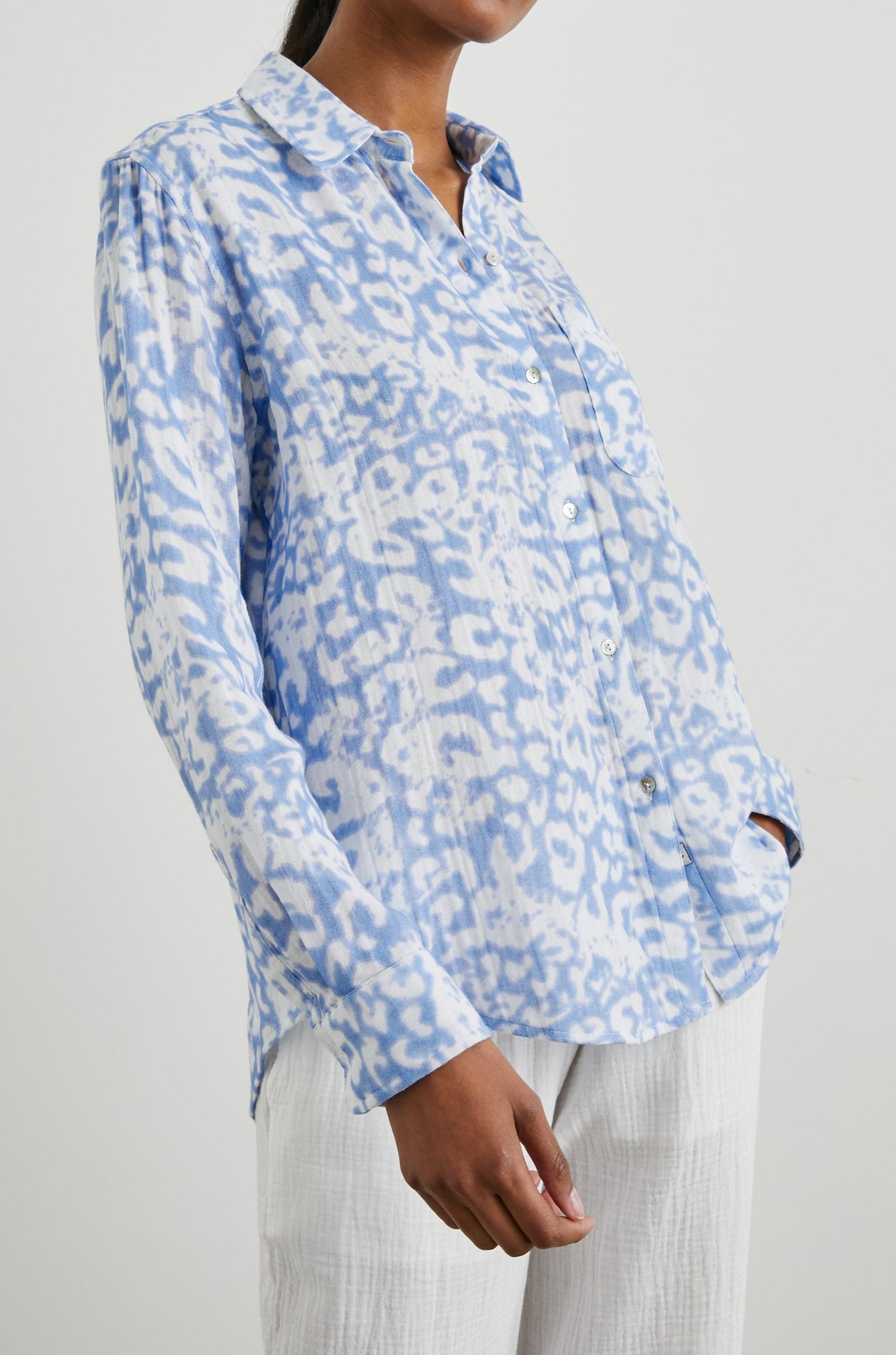 Ellis Long-Sleeve Button Down with Cuffs and a Chest Pocket in Blue Diffused Cheetah Colorway, with a diffused cheetah spot pattern - Front Untucked View Featured on Model