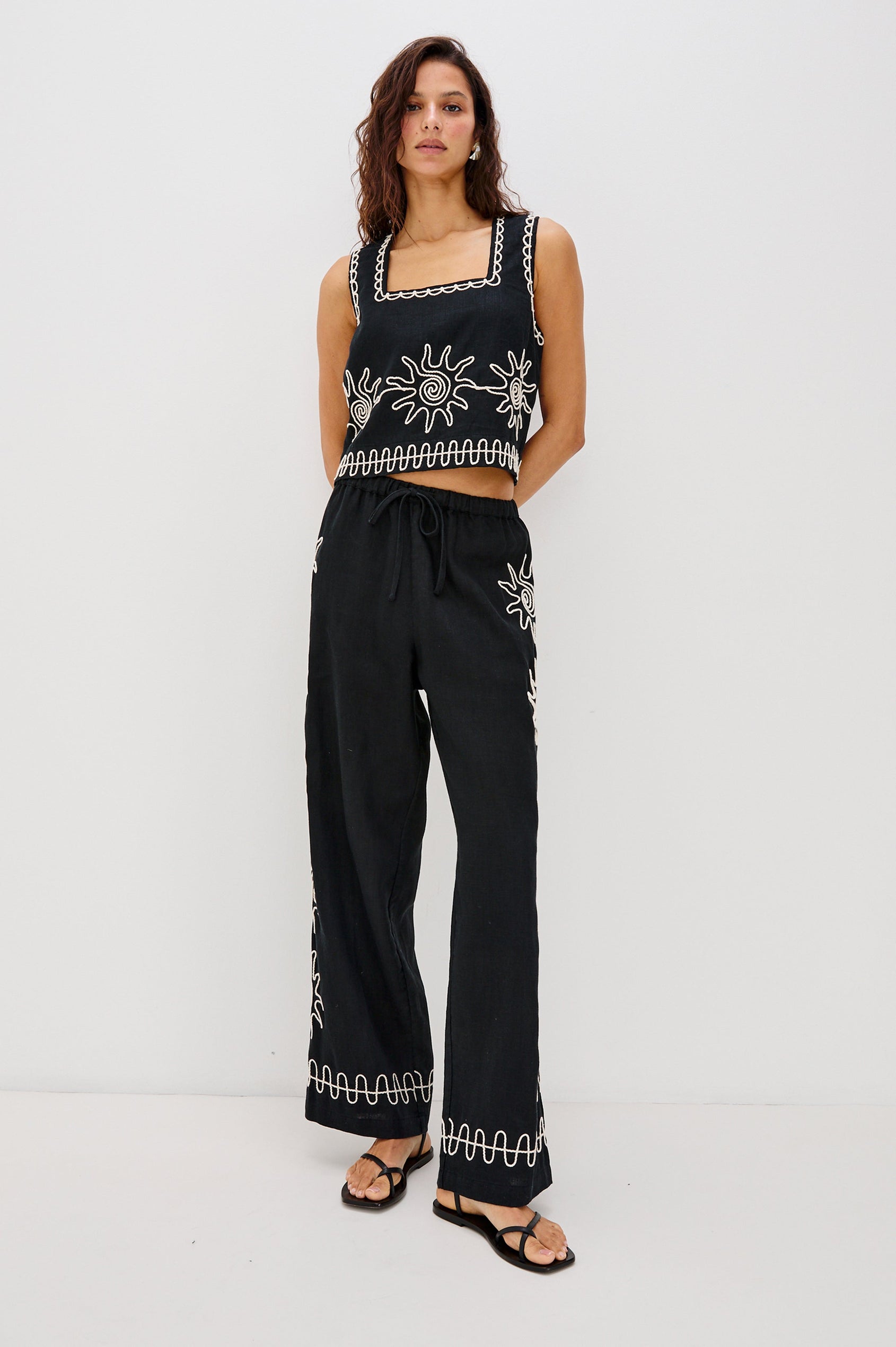 Emmie Straight Leg Pant with Adjustable Drawstring at Waist in White Contrast Sun Embroidery Colorway. Full Body Front View Shown on Model.