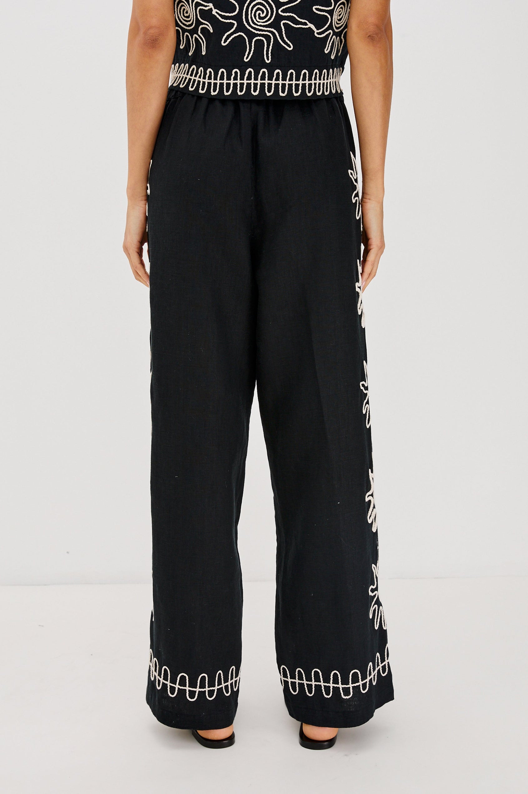 Emmie Straight Leg Pant with Adjustable Drawstring at Waist in White Contrast Sun Embroidery Colorway. Back View Shown on Model.