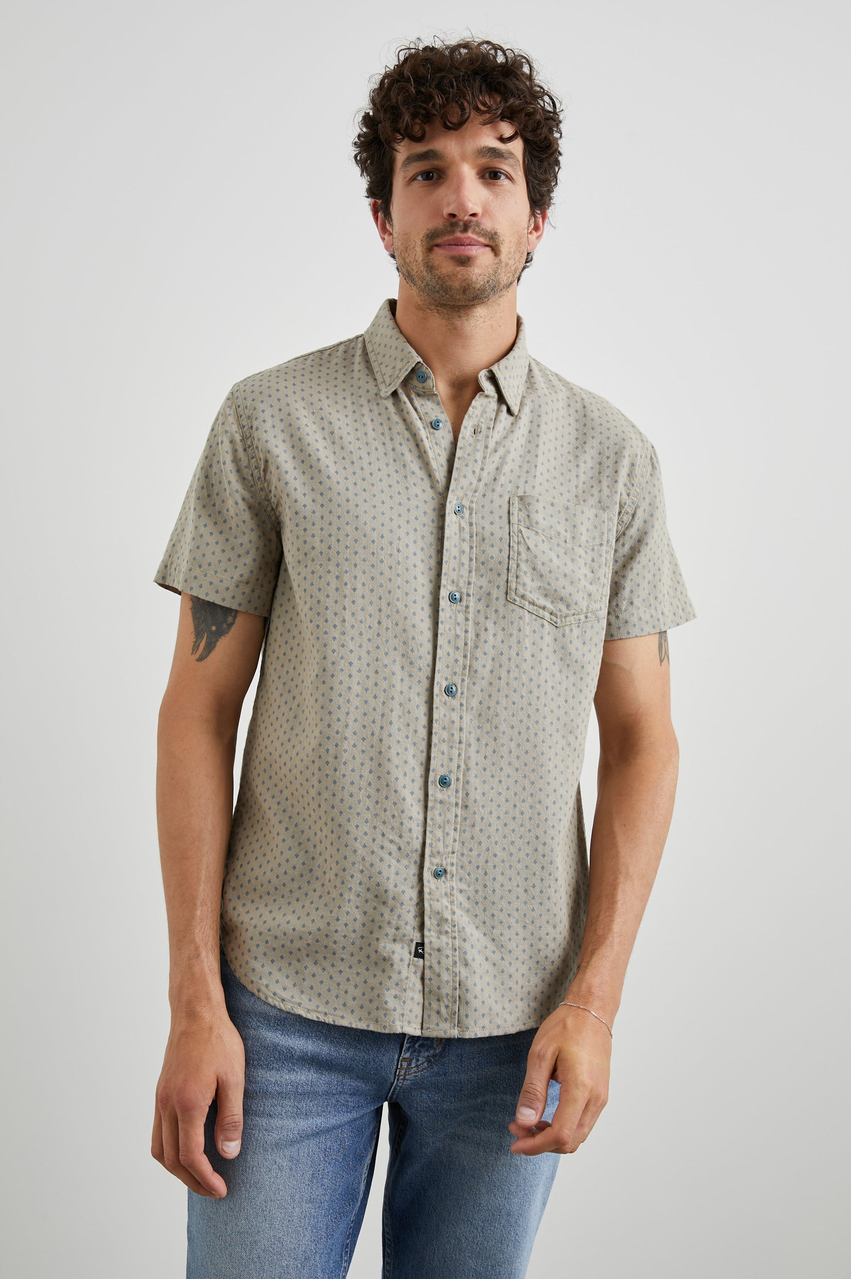 Fairfax Short-Sleeve Button Up with a Chest Patch Pocket in Polygon Micro Quinoa Colorway, with small Grey polygons on Quinoa - Front View Featured on Model