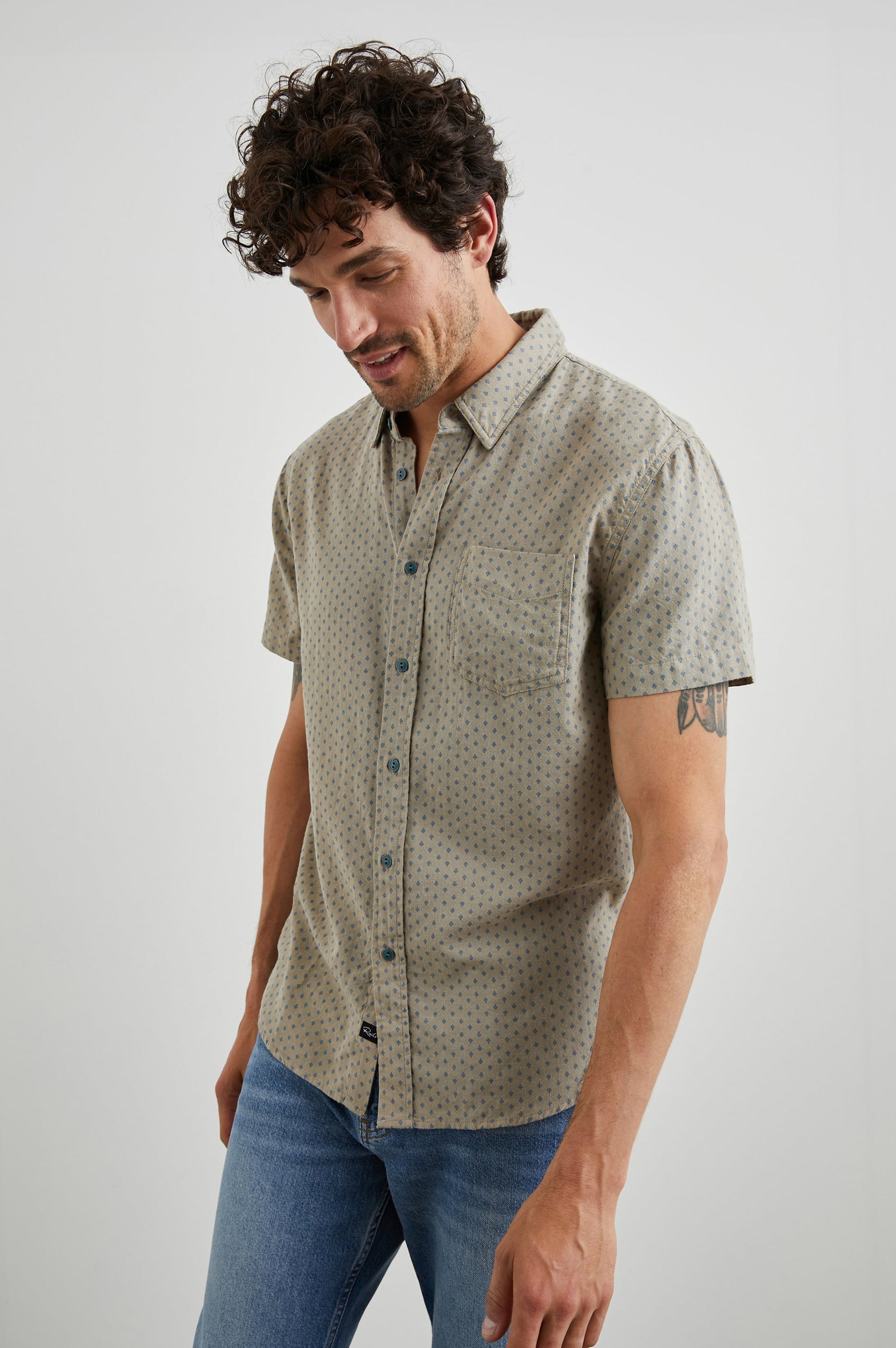 Fairfax Short-Sleeve Button Up with a Chest Patch Pocket in Polygon Micro Quinoa Colorway, with small Grey polygons on Quinoa - Front View Featured on Model