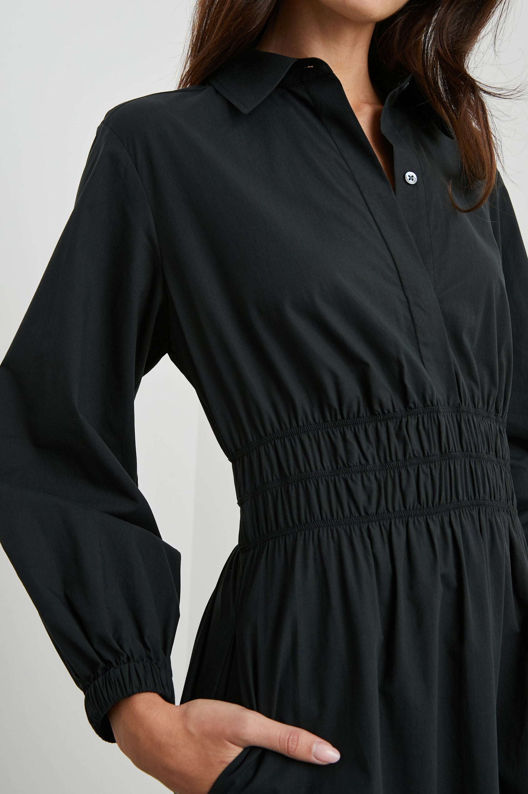 Fraya Long-Sleeve Midi Dress with a Concealed Button Placket on the Bodice, a Collar, a Shirred Waist, and Two Hip Pockets in Black Colorway - Front View Featured on Model
