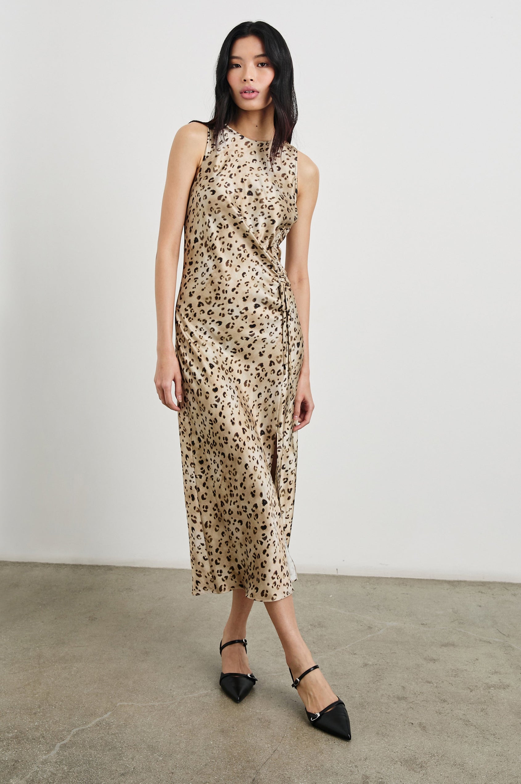 Gabriella Sleeveless Midi Dress with a Crew Neck, a Left Thigh Side Slit, a Ruched Drawstring on the Left Side and a Keyhole Button Closure at the Back in Champagne Leopard Colorway, with Black and Brown Spots on Champagne - Front Full Body View Featured on Model